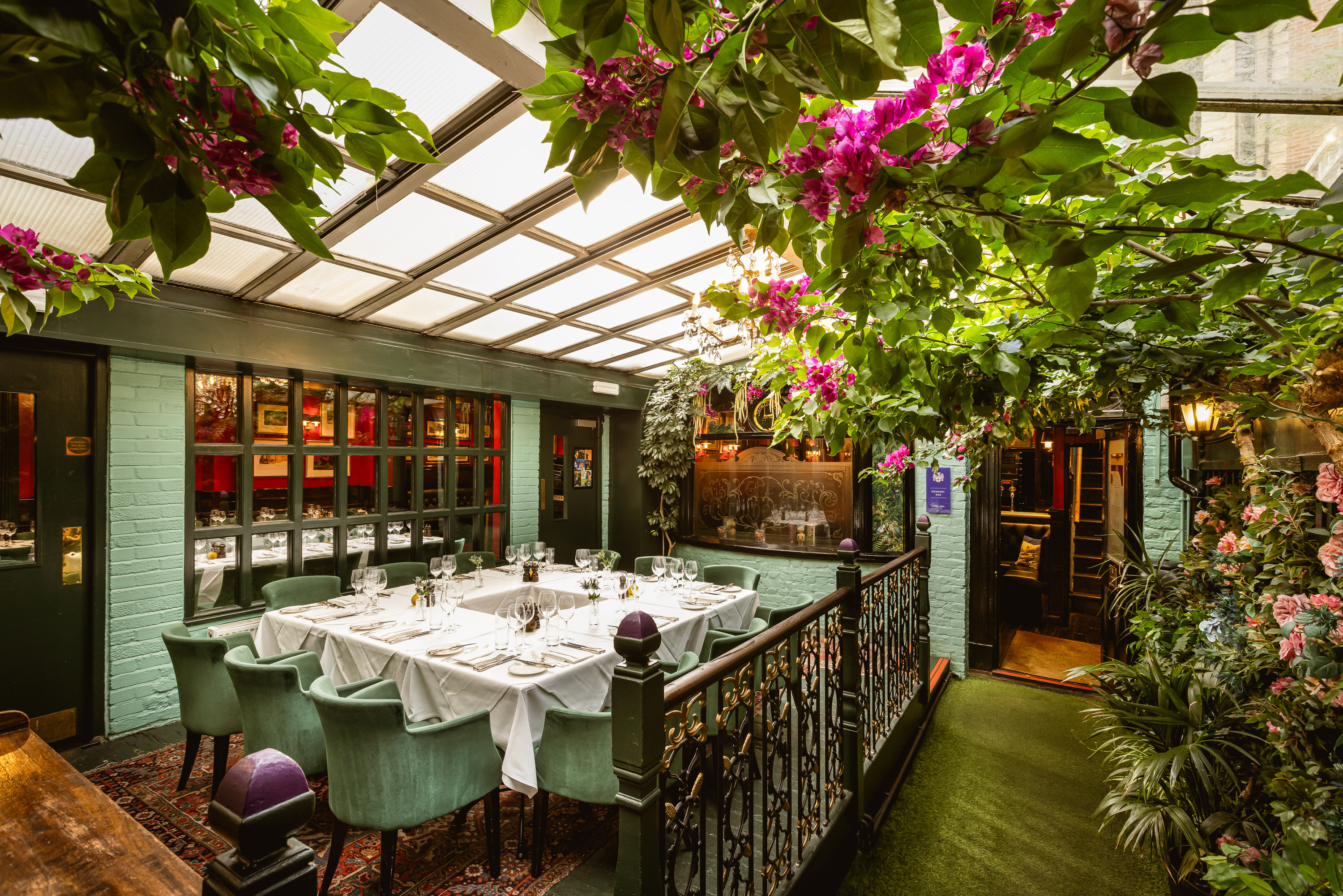 Courtyard Garden event space in Boisdale, featuring lush greenery and elegant table settings.