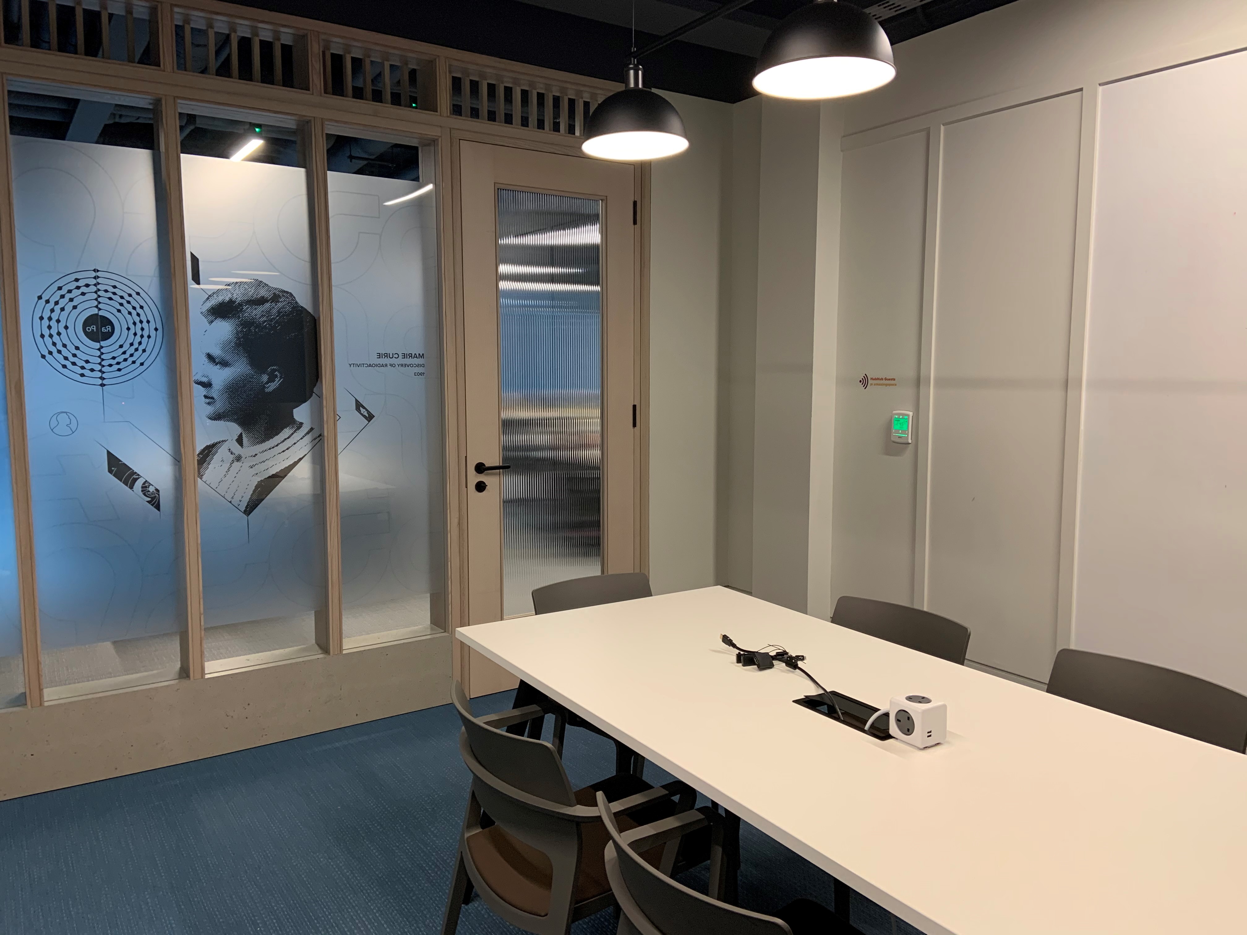Modern meeting room with glass walls, sleek table for collaborative sessions in HubHub Farringdon.