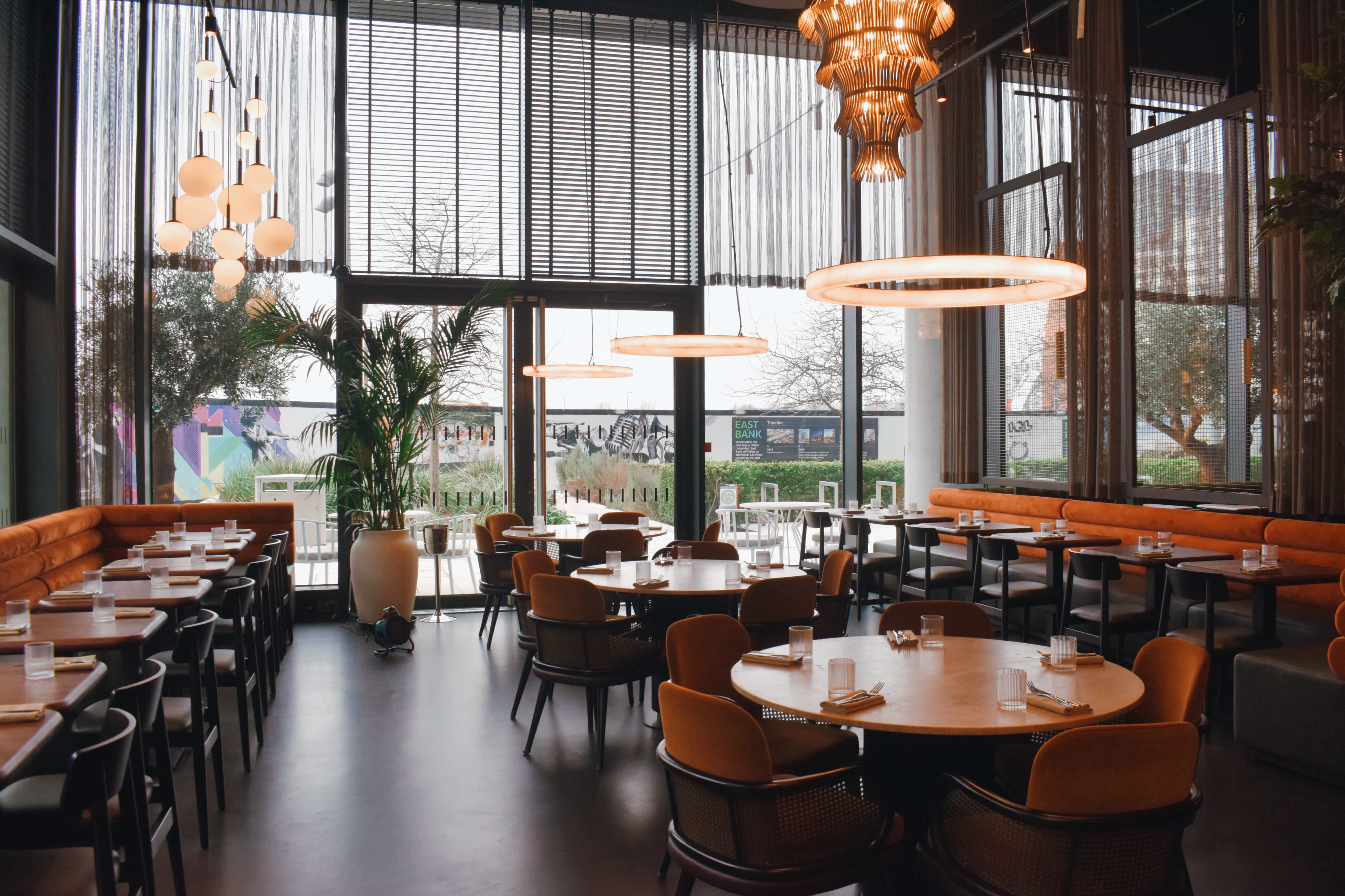 Iris Hall at HERA Restaurant: modern dining space for events with natural light and stylish decor.