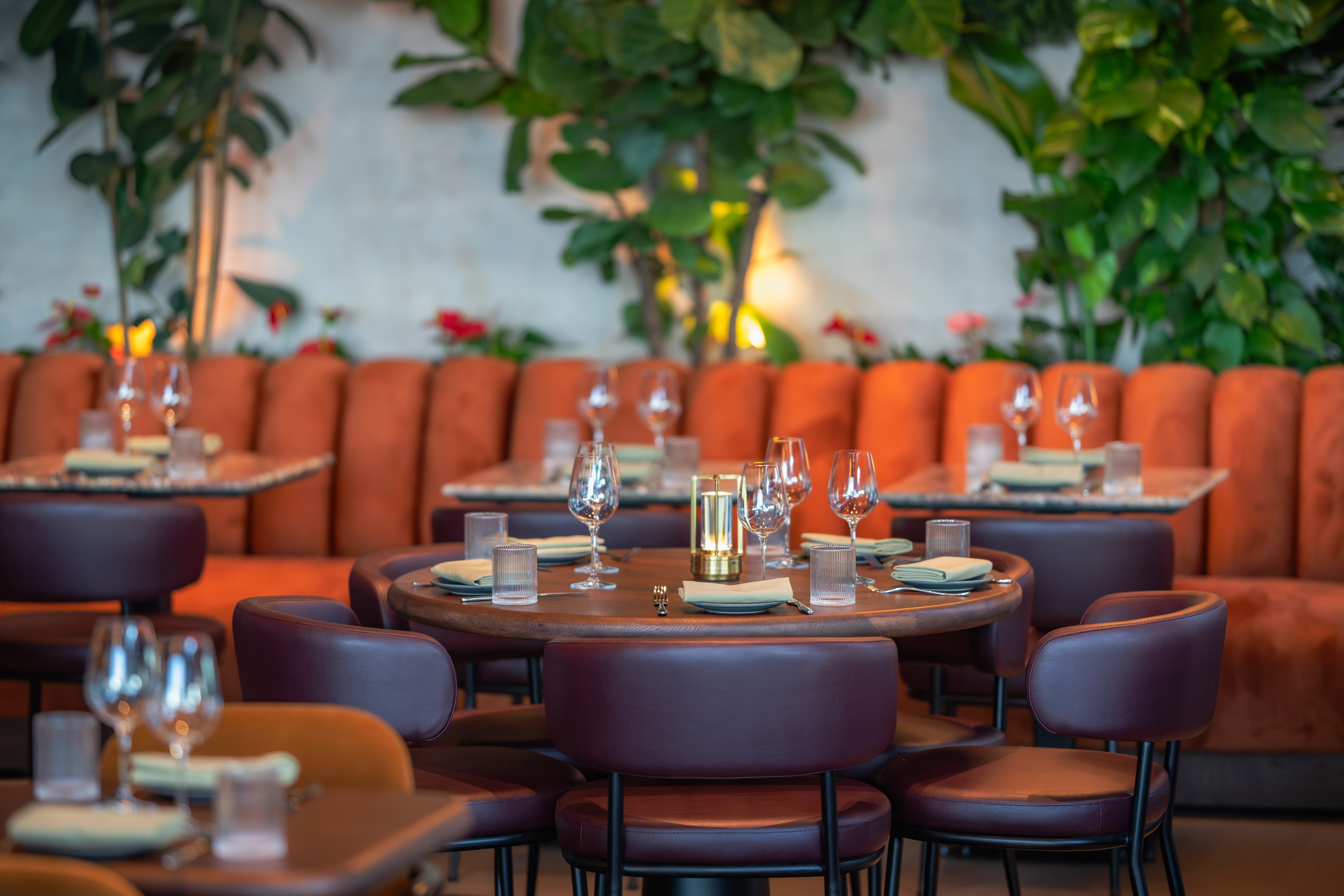 Edena Room at HERA Restaurant with cozy orange seating for upscale events and gatherings.