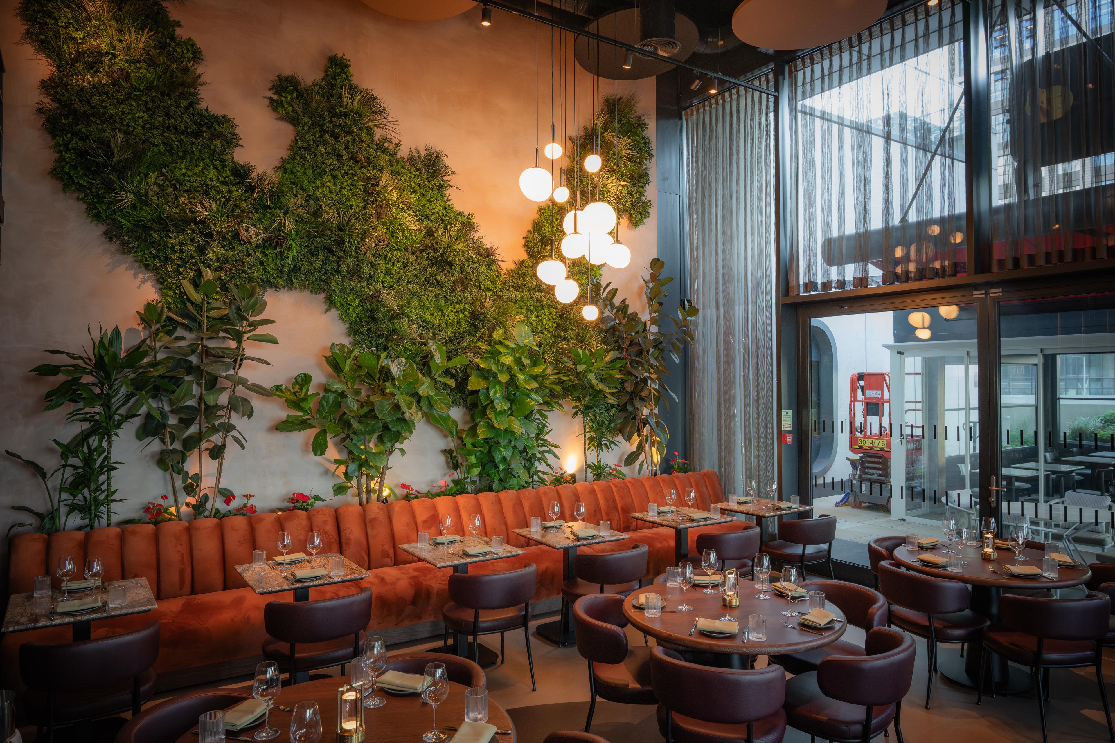 Edena Room at HERA Restaurant: modern decor, lush greenery for events and gatherings.