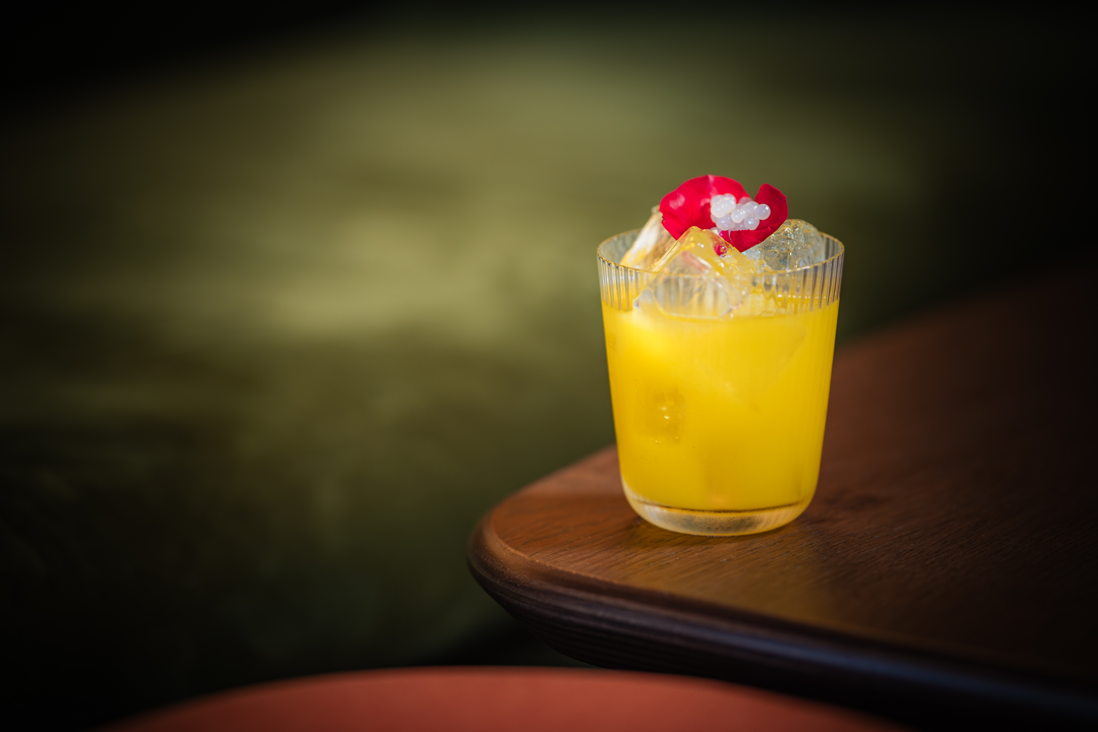 Vibrant cocktail with cherry garnish at Elysium Lounge, perfect for networking events.