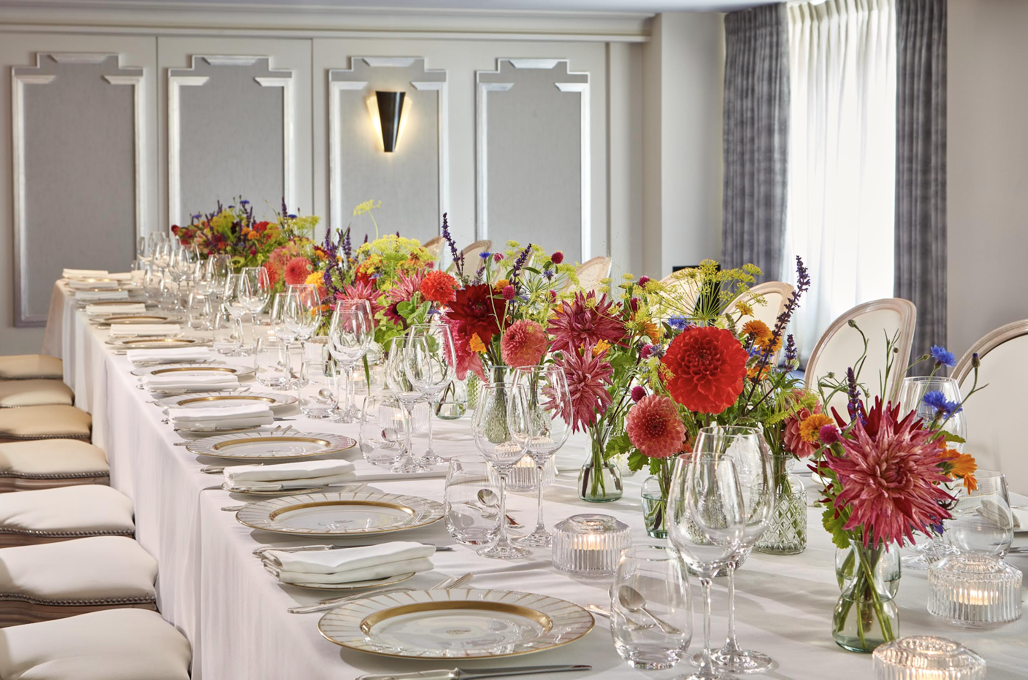 Elegant banquet table at Claridge's with floral centerpieces for corporate events.