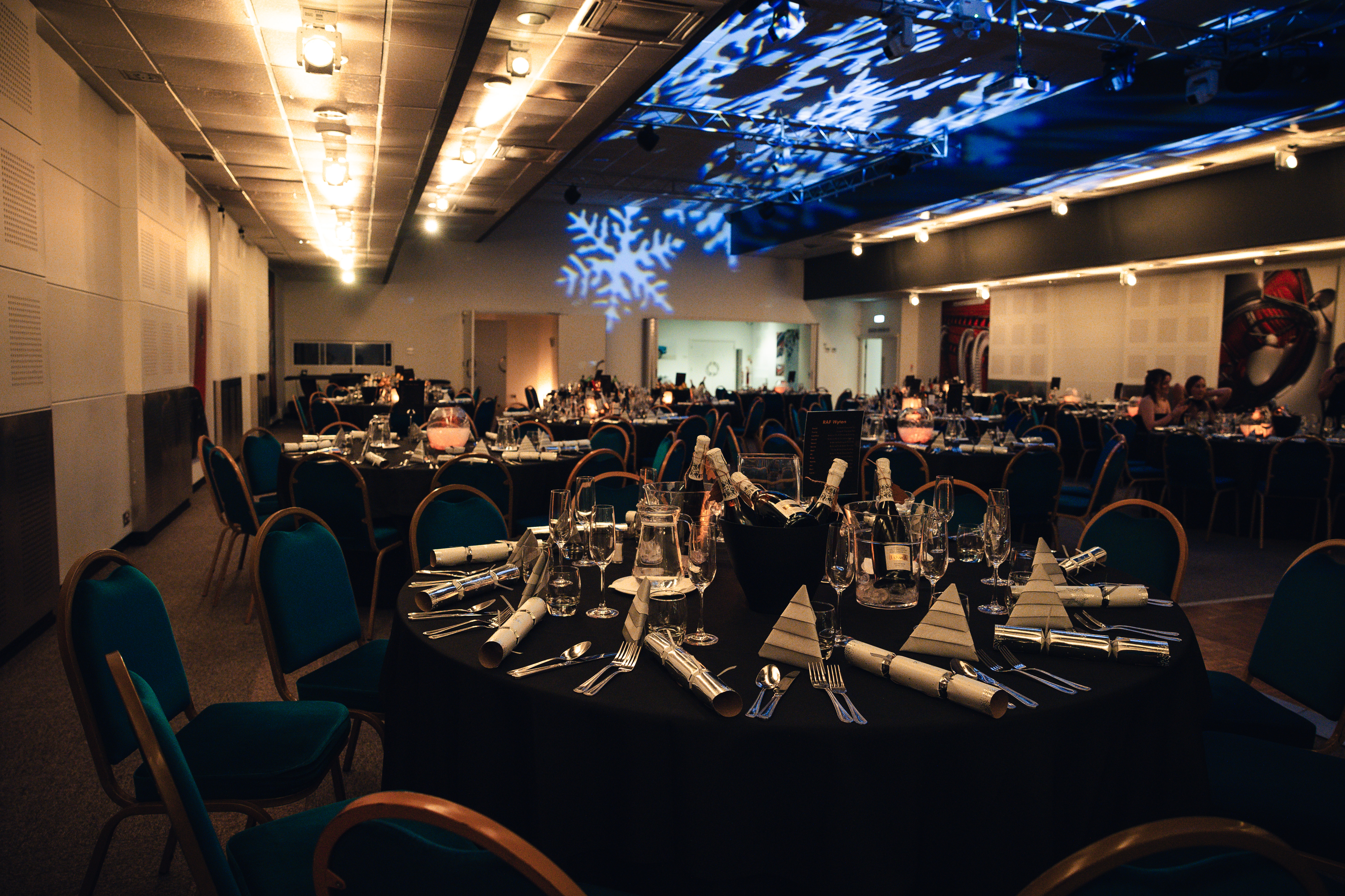 Elegant banquet room in Merlin Suite with black linens, ideal for upscale events and celebrations.