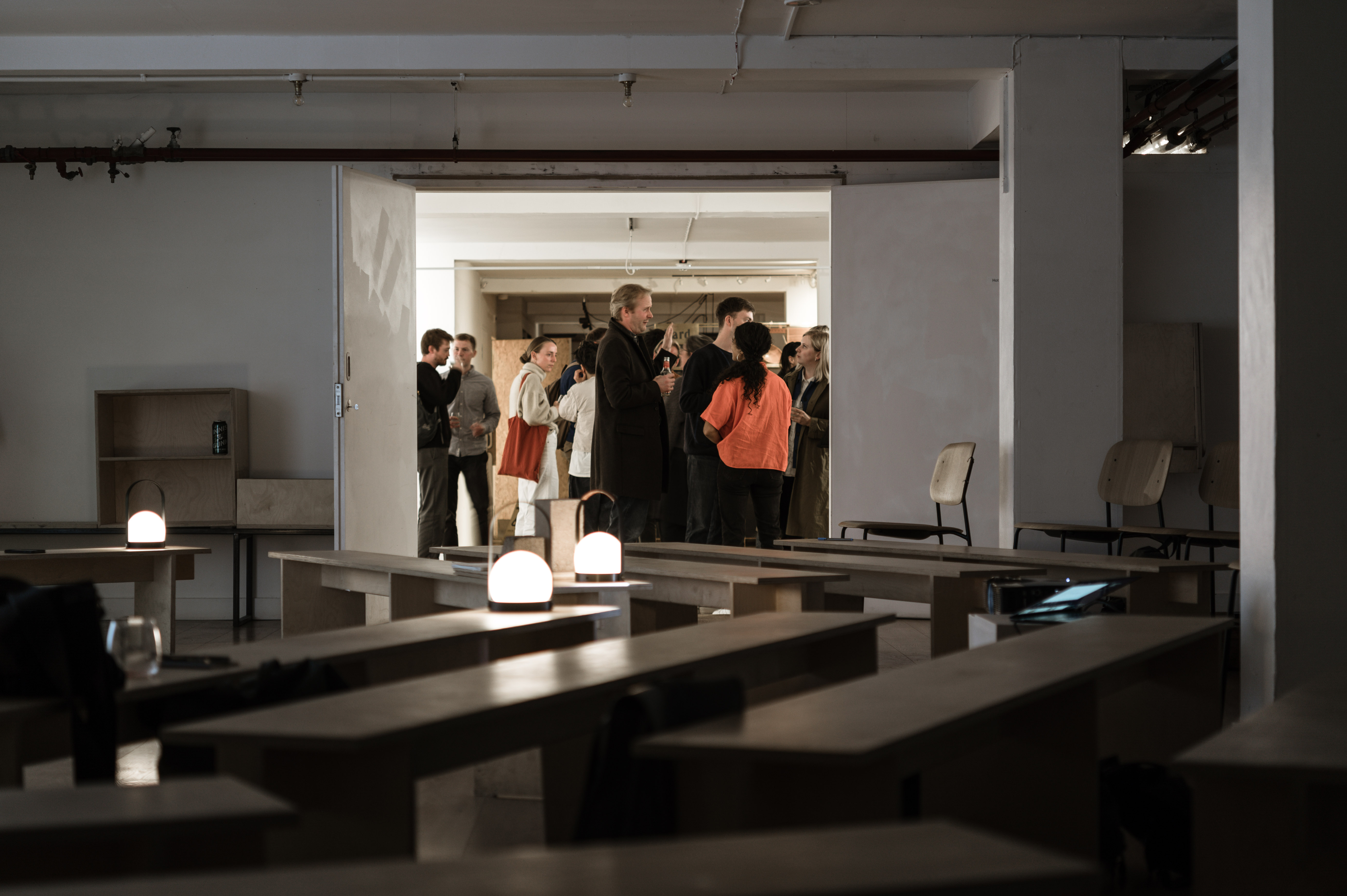 Minimalist event space in Custom Lane with warm lighting for networking and gatherings.