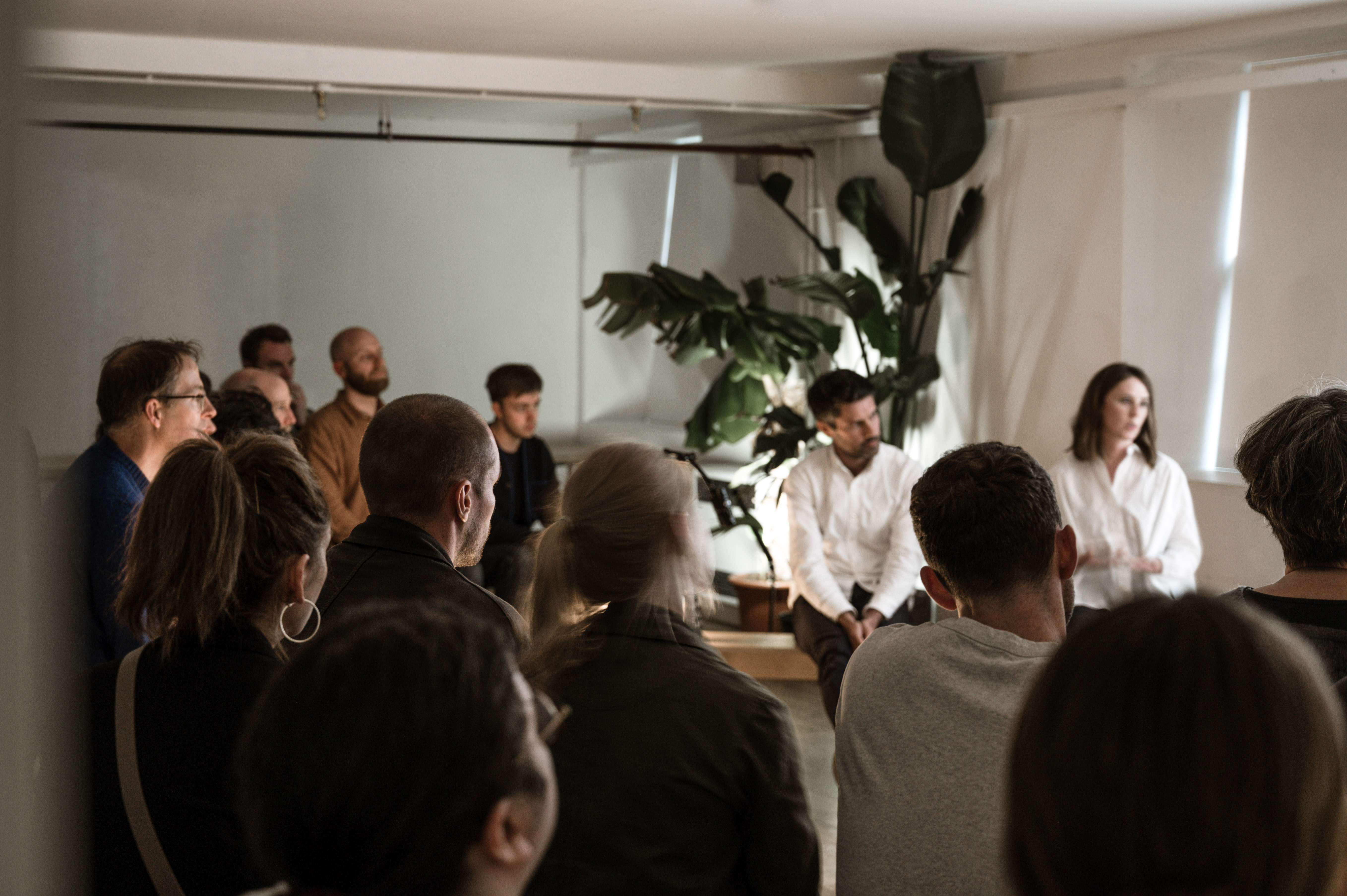 Event Space in Custom Lane with engaged participants at a panel discussion for networking.