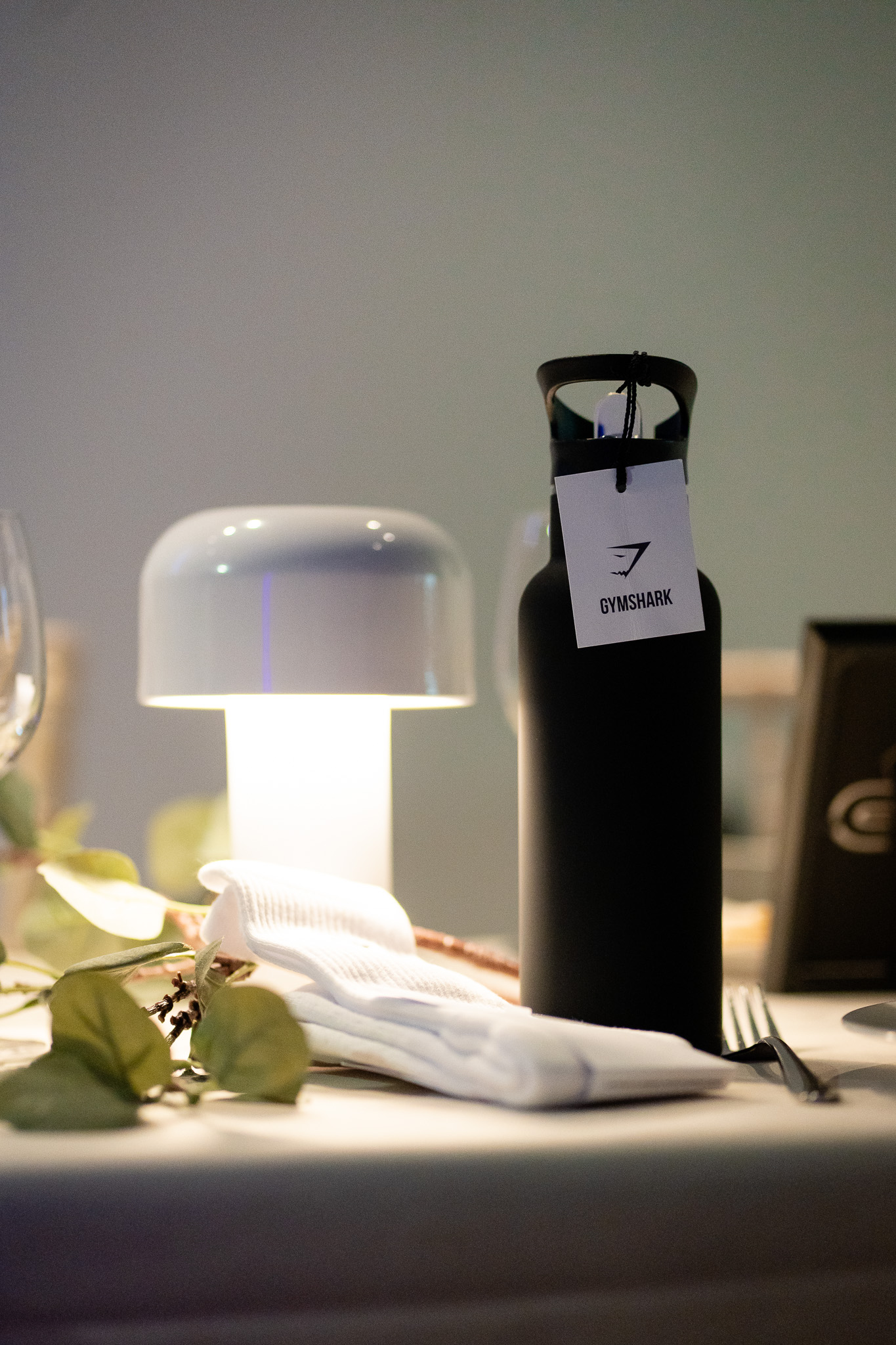 Sleek water bottle and lamp in Qube Elephant Lounge for stylish event hydration.