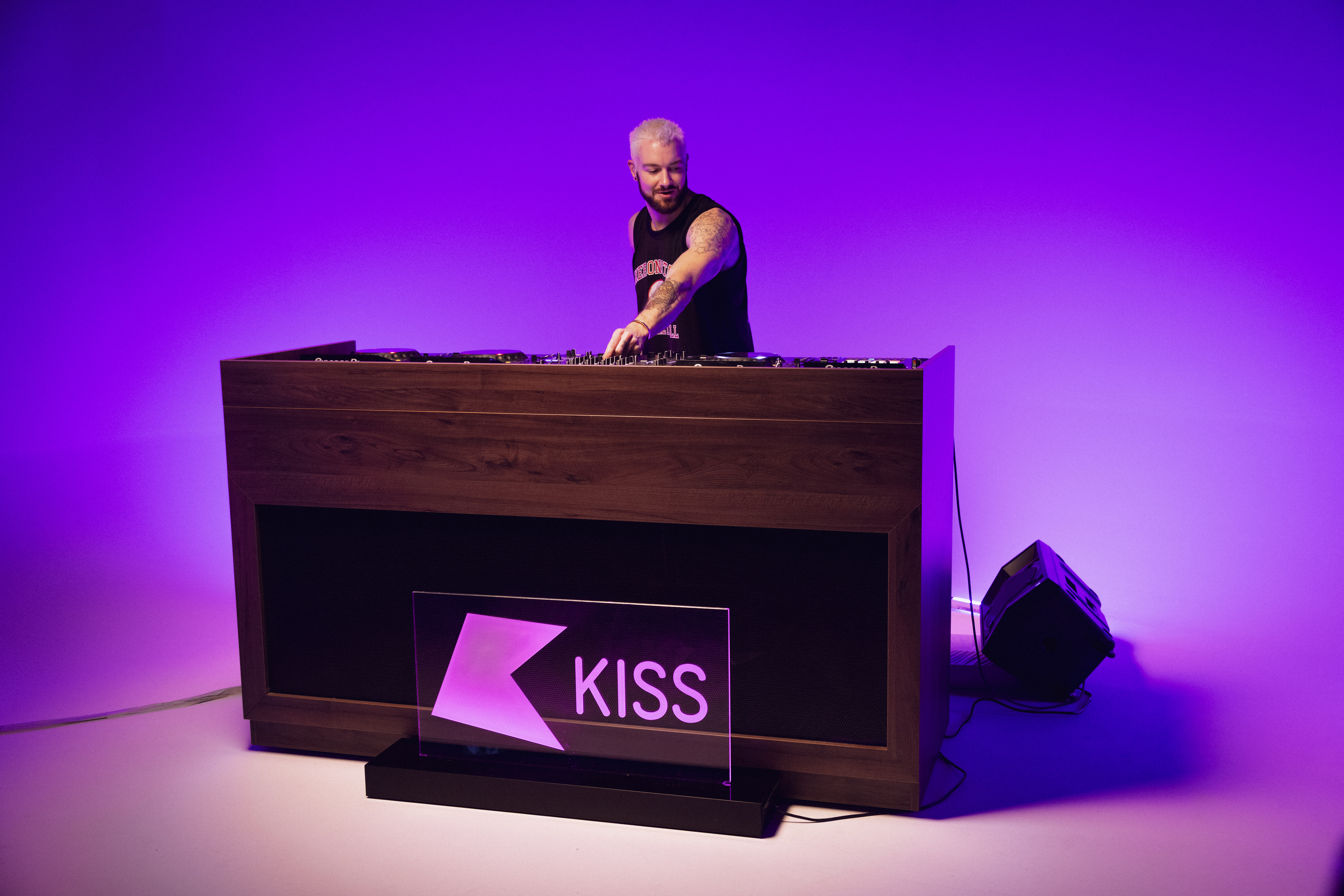 DJ performing at Qube Elephant Lounge with vibrant purple lighting for events and parties.