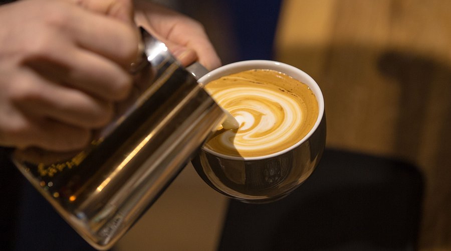 Barista latte art, premium coffee break, conference cafe