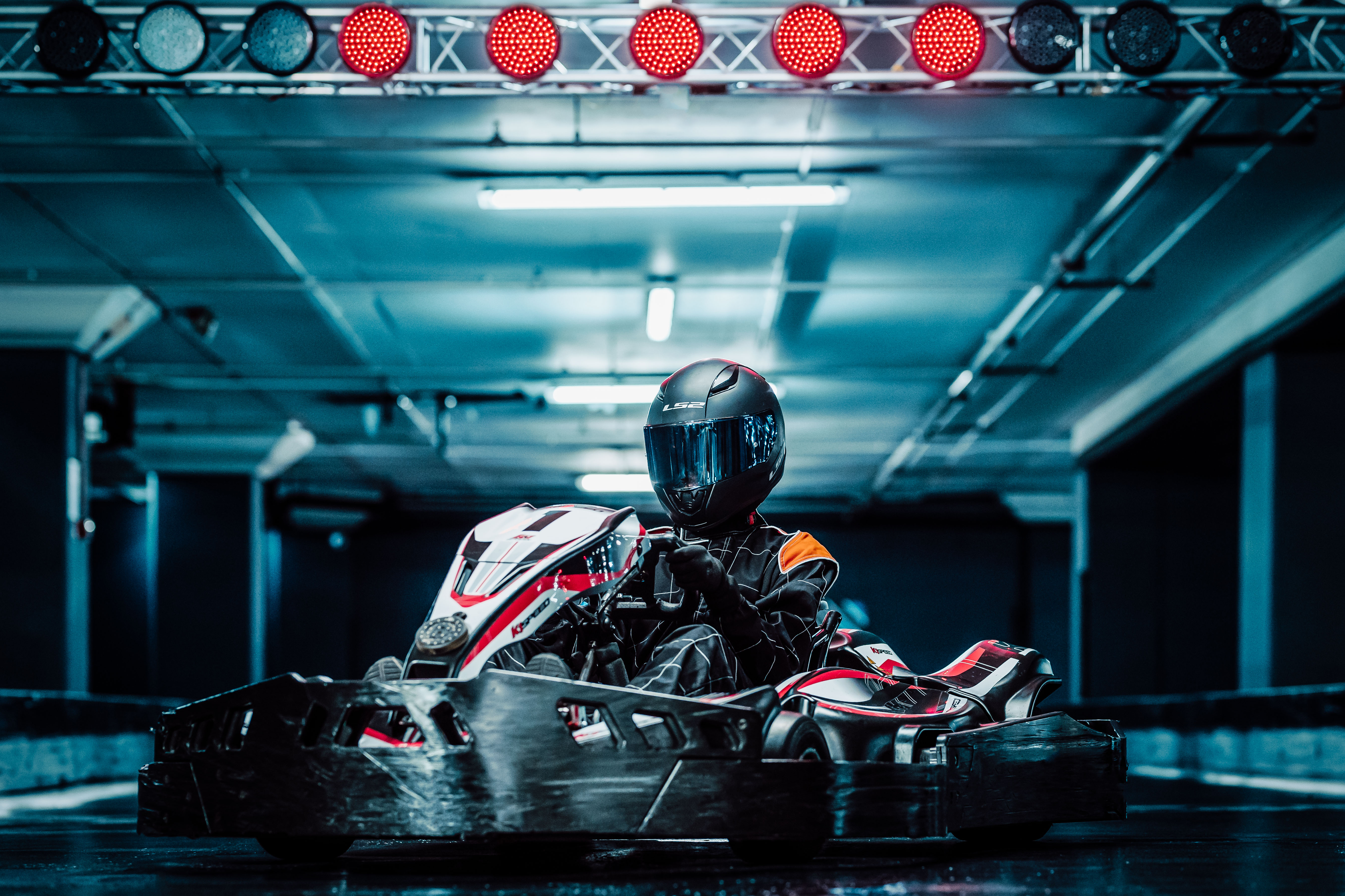 Sleek go-kart in modern indoor racing venue for corporate events and team-building.