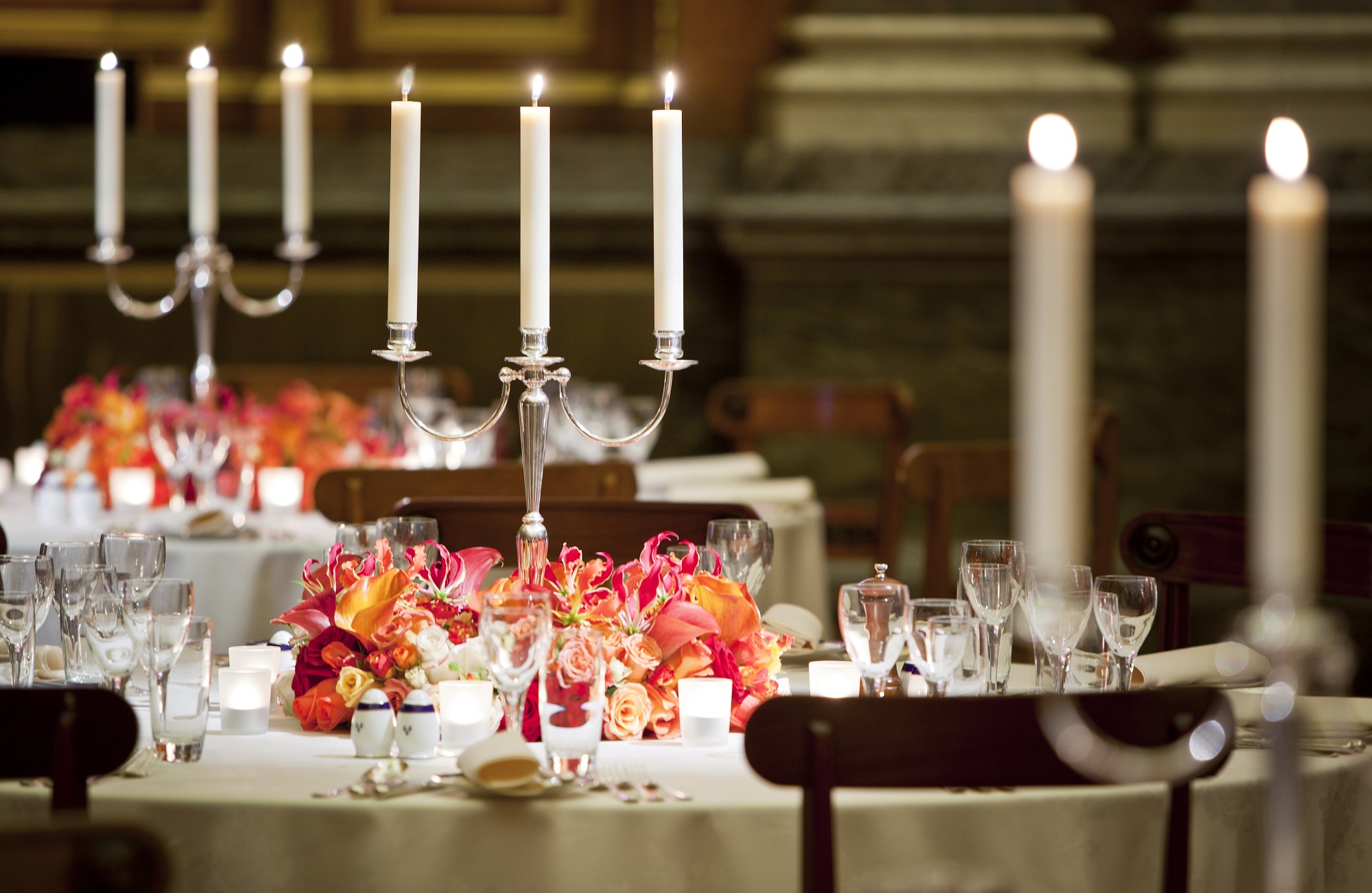 Elegant dining table with tall candlesticks in Livery Hall for formal events.