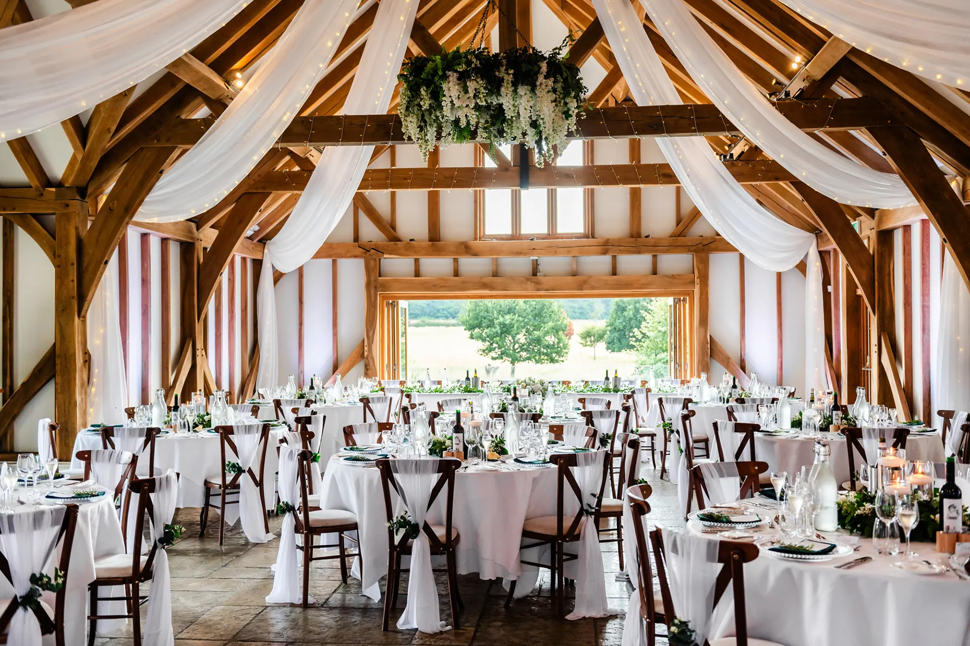 Elegant Barn venue with rustic beams, perfect for weddings and upscale events.