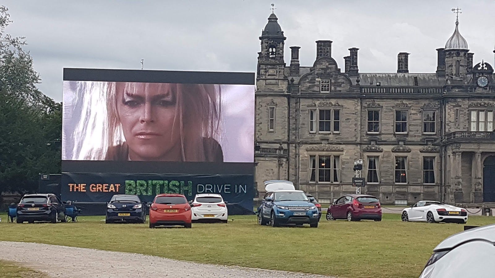 Wedding marquees at Sandon Hall with outdoor screen for a drive-in movie event.
