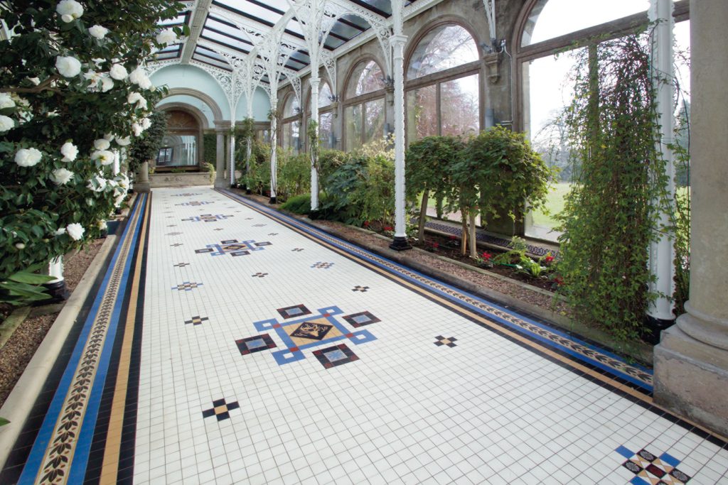 Historic Conservatory in Sandon Hall: elegant corridor with lush greenery, ideal for events.