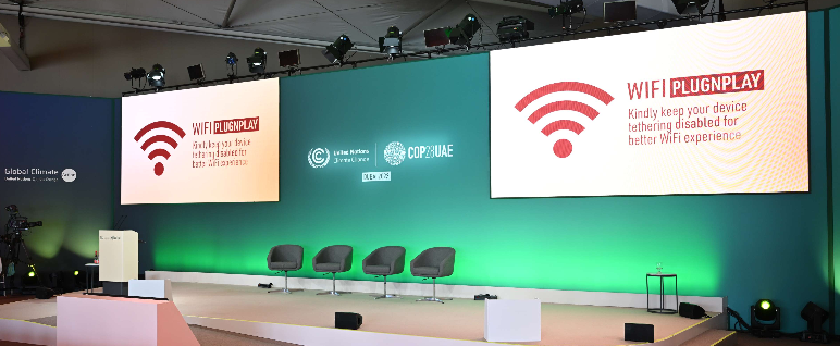 Professional event stage with dual-screen projection for corporate conference and keynote setup.