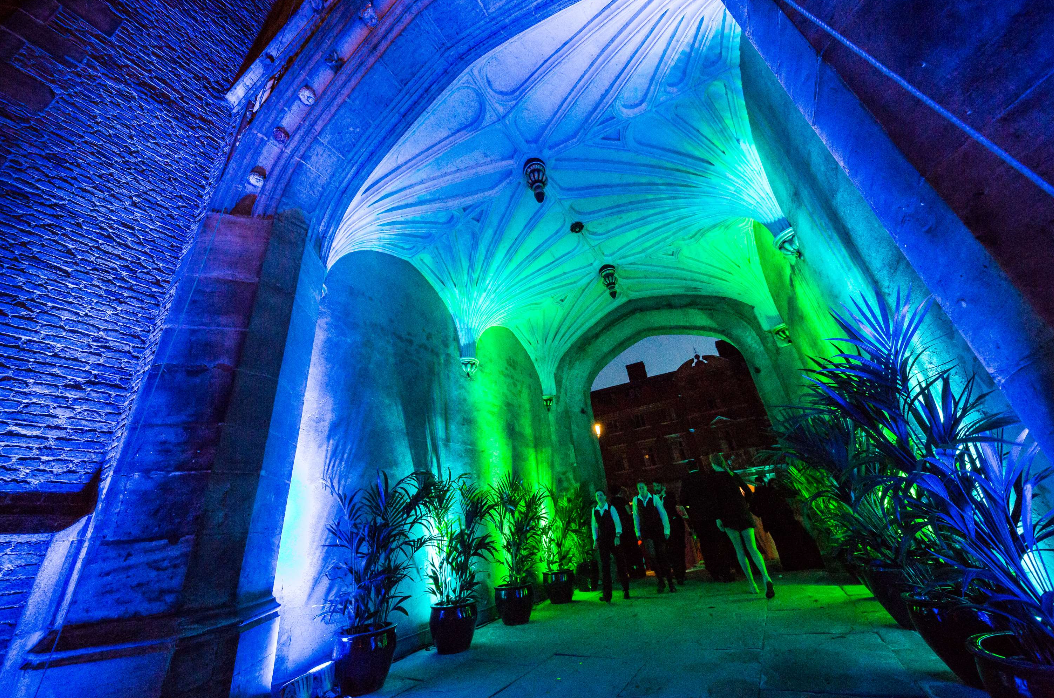 Branded stone passage with LED lighting for immersive evening event arrival.