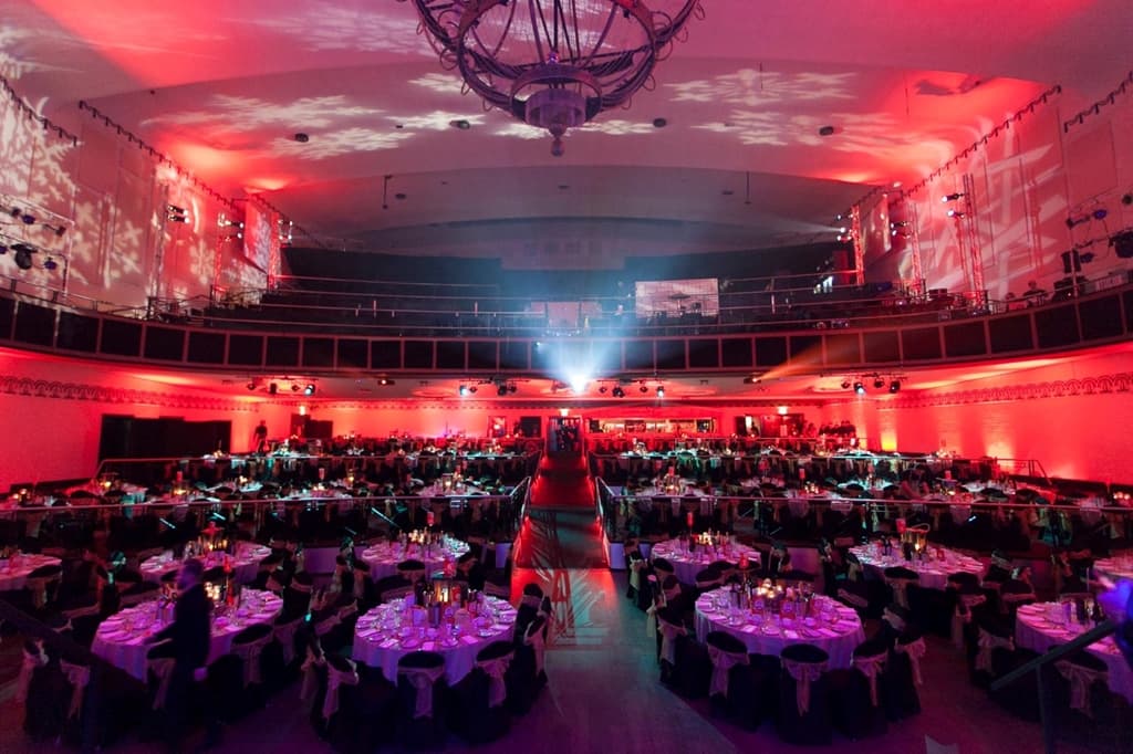Elegant Cinema Suite in Athena, with dark table linens and red lighting for corporate events.