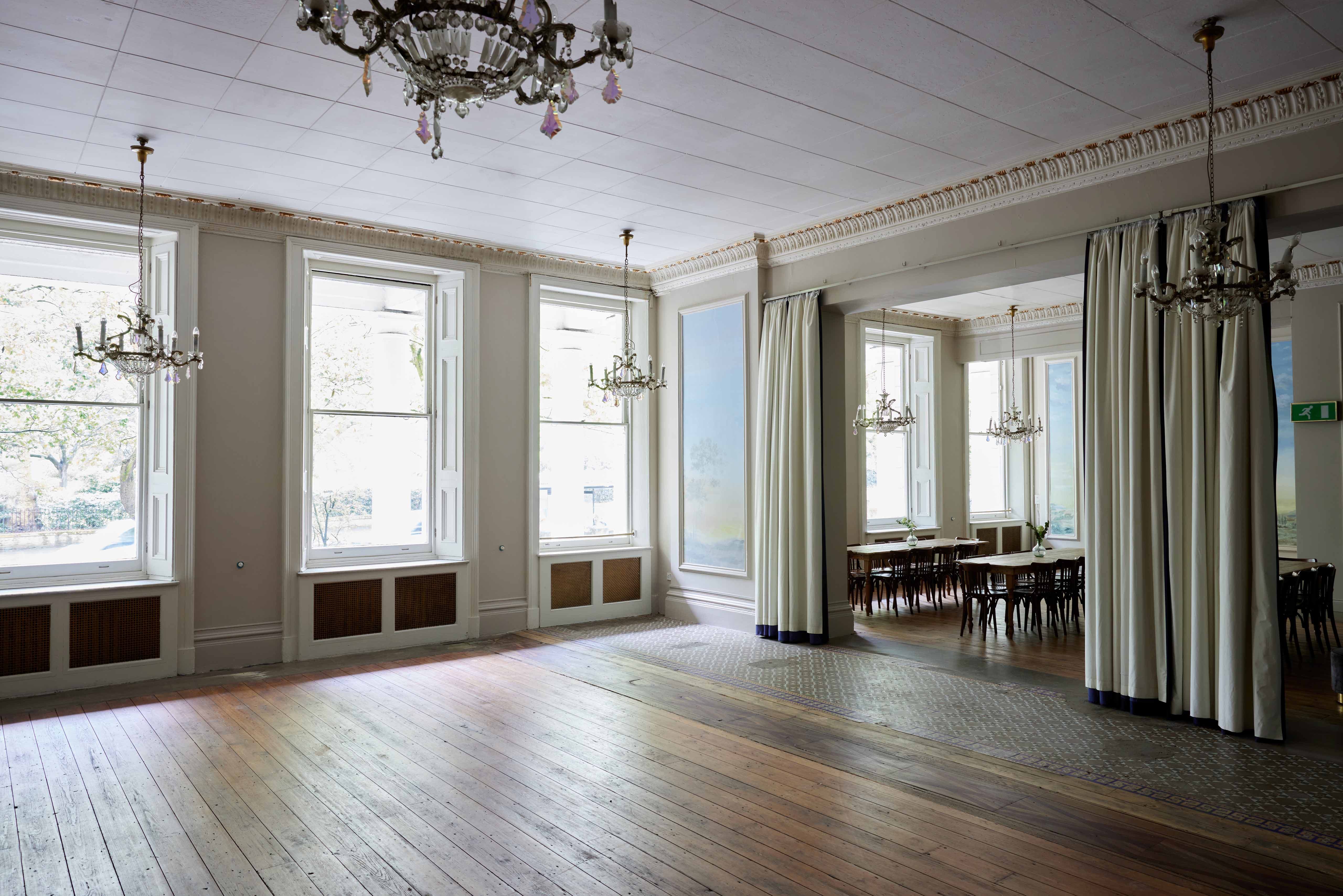 Elegant Bayswater Suite with tall windows, perfect for events and gatherings.