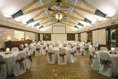 Elegant Olympic Pavilion event space with round tables, ideal for formal dinners and celebrations.