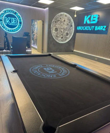 Branded pool table in Knockout Barz studio, perfect for corporate team building and networking.