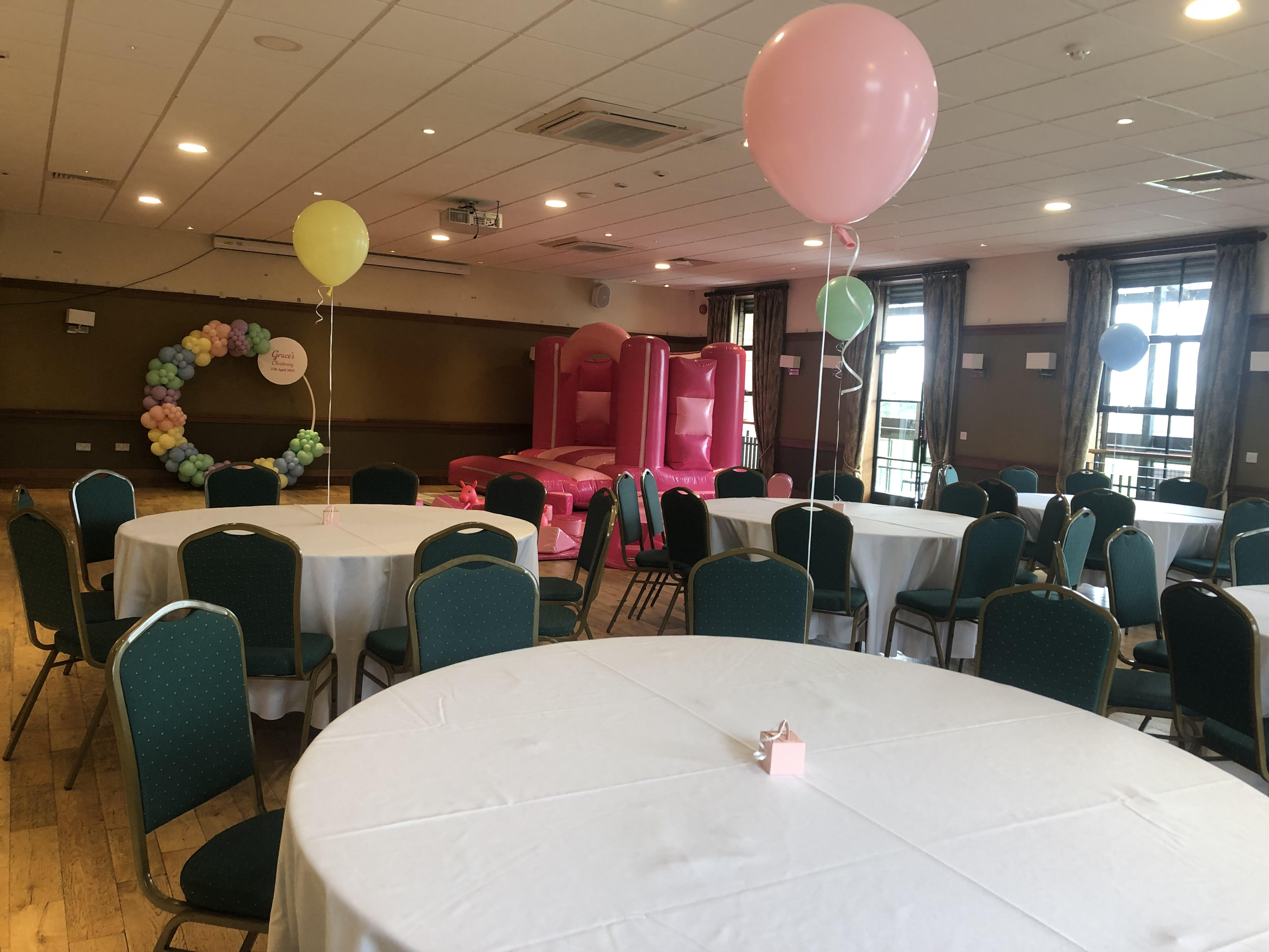 Emerald Hall event space with inflatable castle for kids' birthday parties and social gatherings.