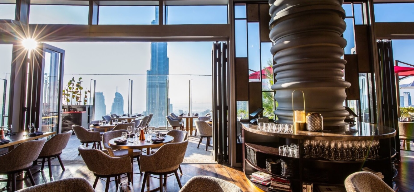 Lounge at Address Sky View: elegant dining with city skyline views for corporate events.