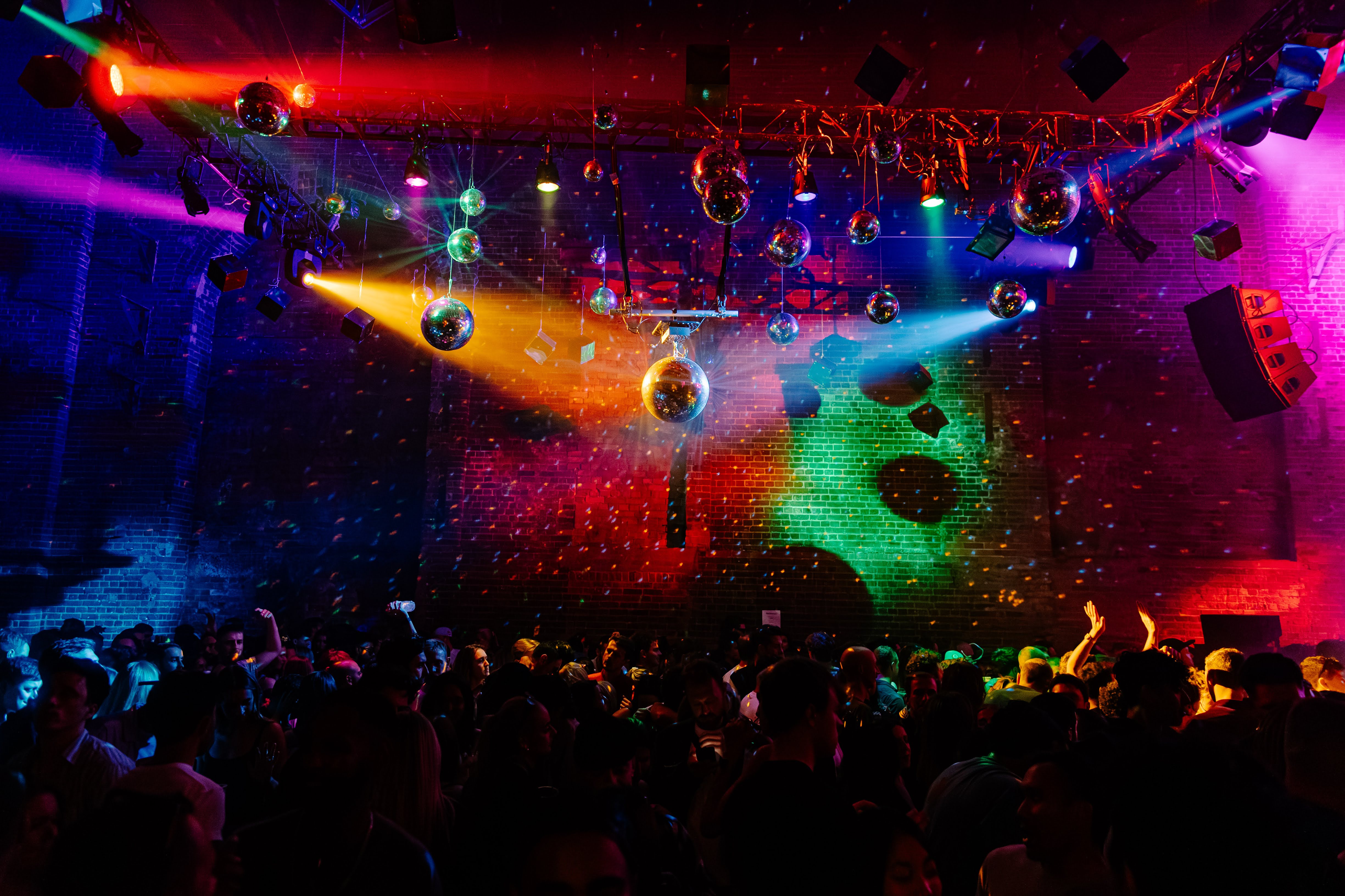 Vibrant Village Underground event space with dynamic lighting and disco balls.