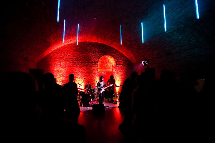 Vibrant live music performance at Village Underground with dramatic lighting for events.