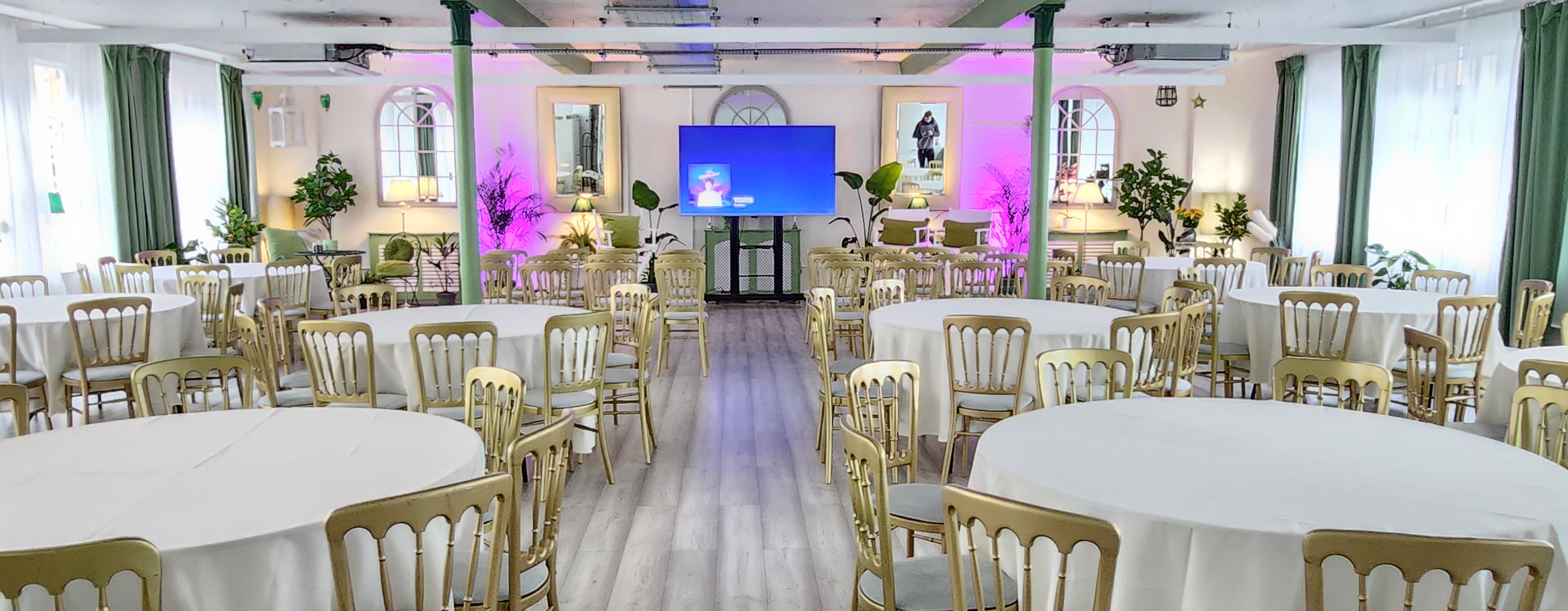 Elegant event space with round tables, ideal for corporate meetings and social gatherings.