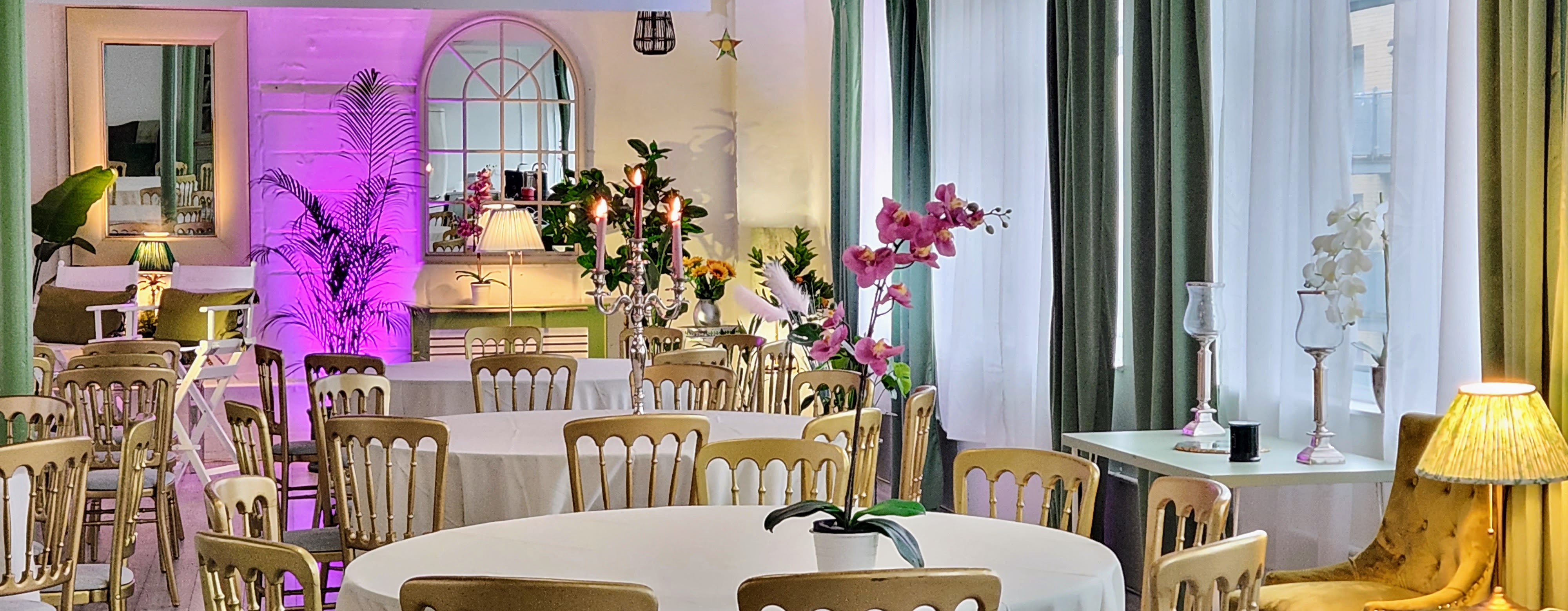 Elegant event space with round tables and floral centerpieces in Lumiere Underwood.