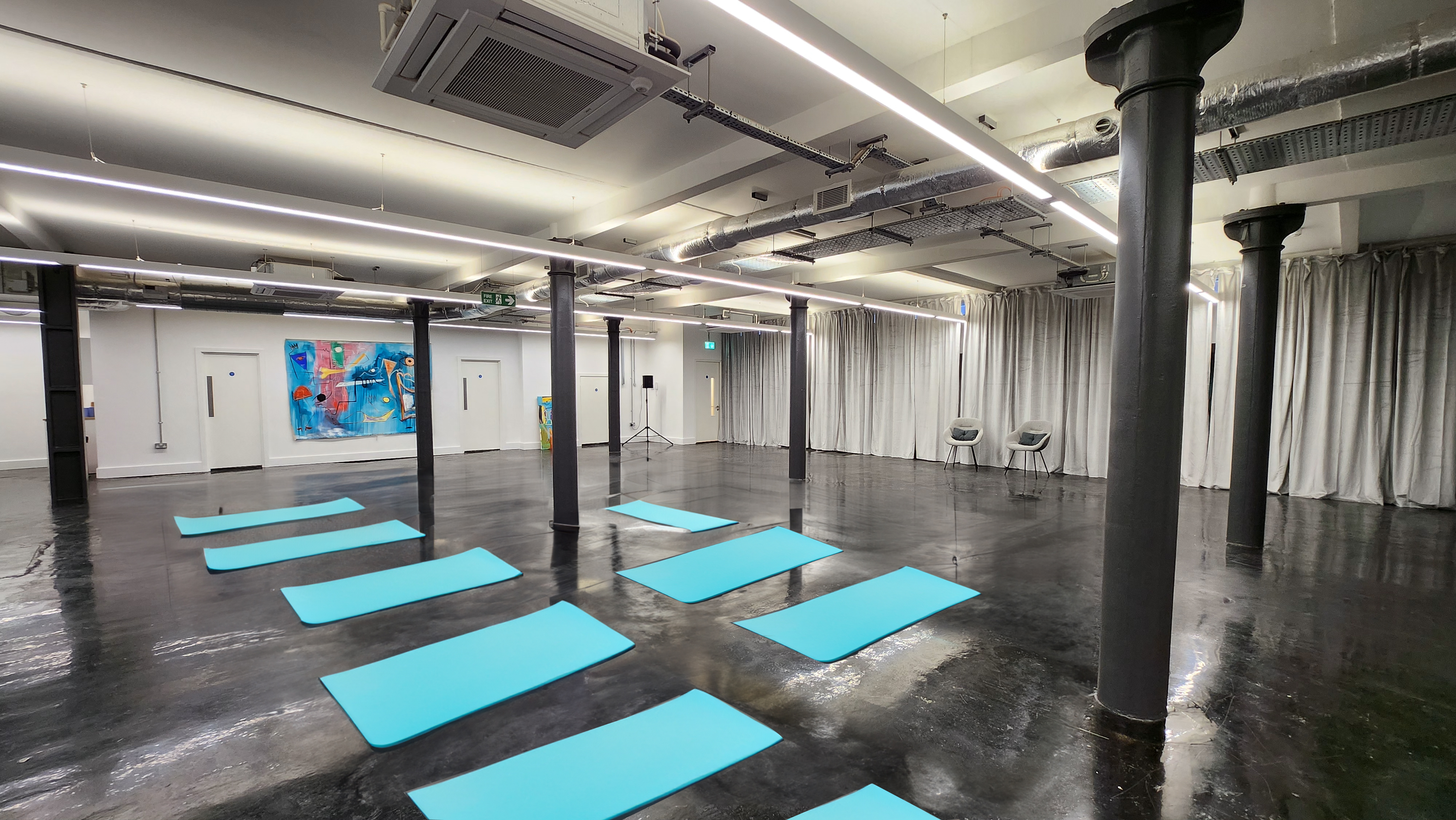 Versatile event space with yoga mats for wellness sessions and corporate retreats.