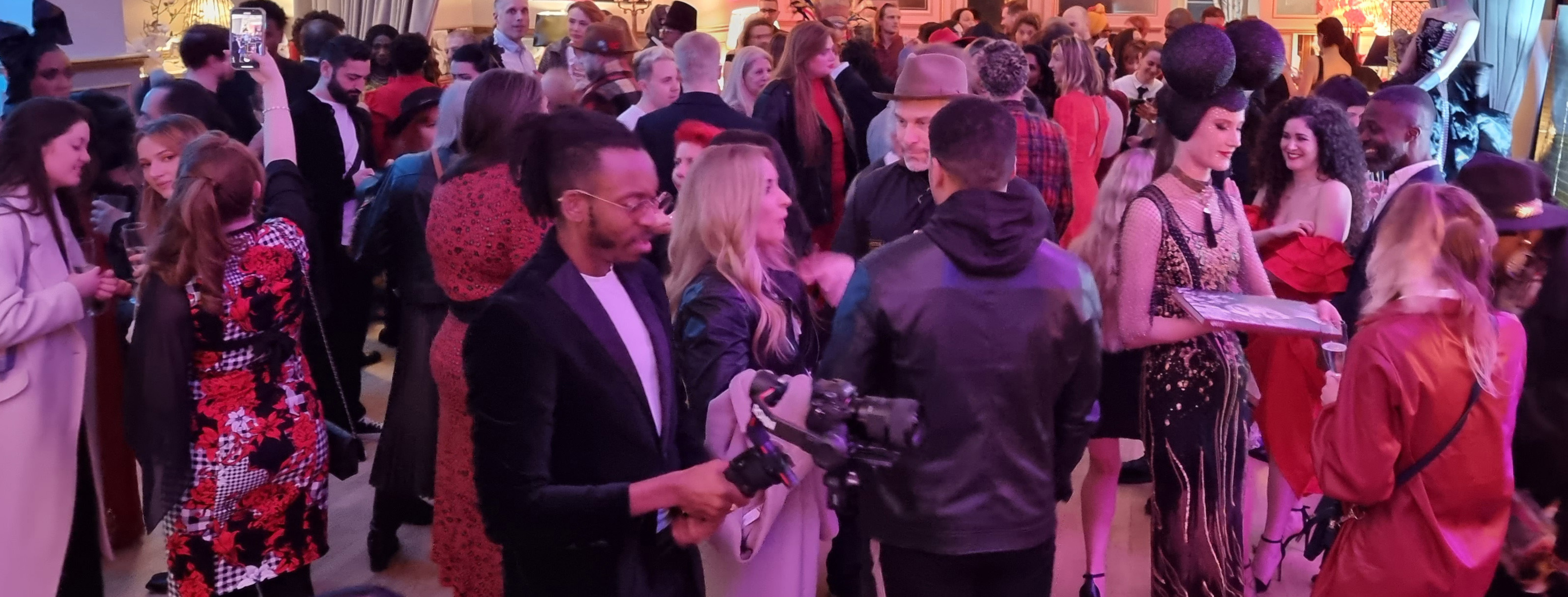 Vibrant networking event at La Galeria with stylish attendees and engaging atmosphere.