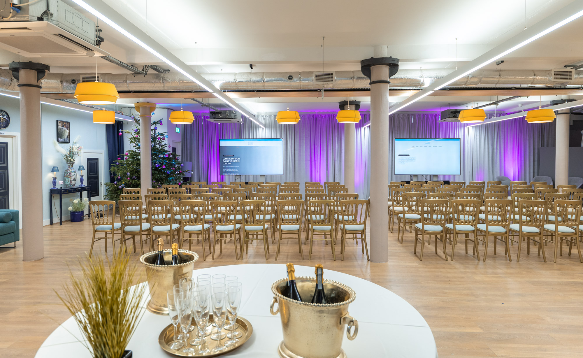 Elegant event space at La Galeria with modern seating and audiovisual setups.