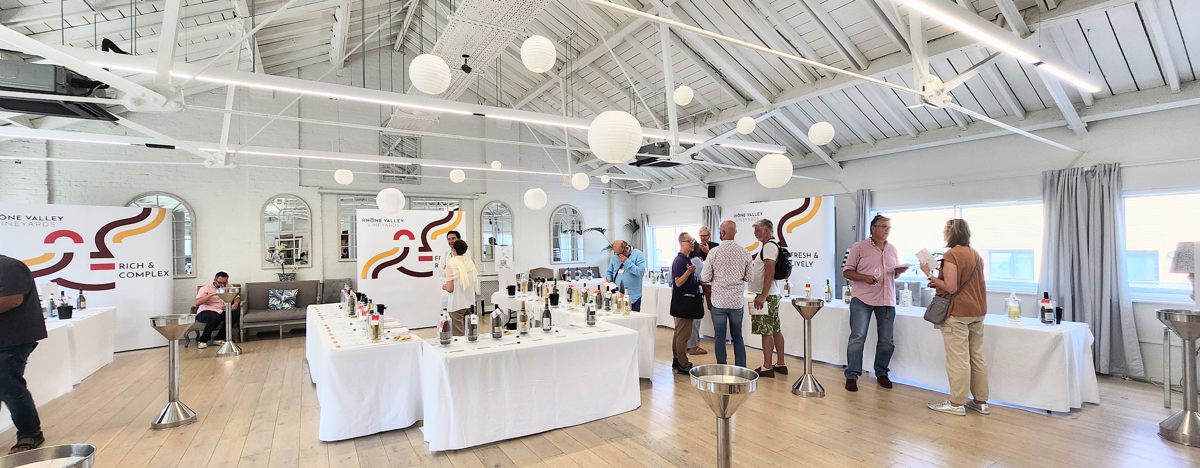 Underwood Flagship Venue with white tables, perfect for networking and tasting events.