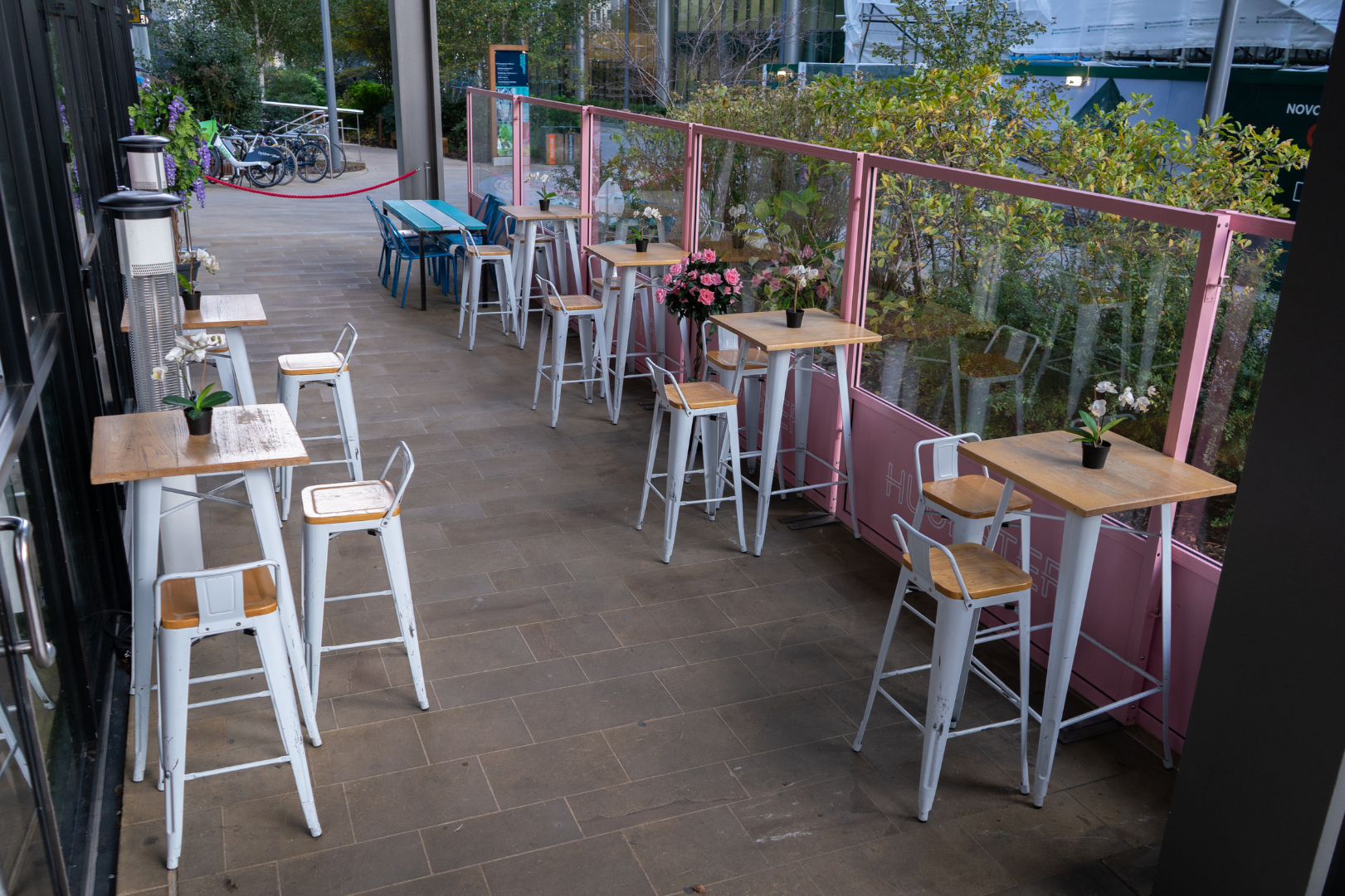 Outdoor venue hire in HUCKSTER London with high-top seating for networking events.