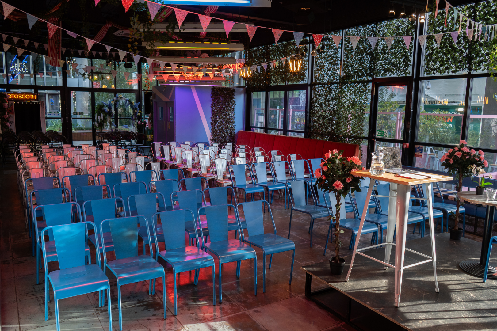 Vibrant event space with blue chairs at HUCKSTER London for presentations or gatherings