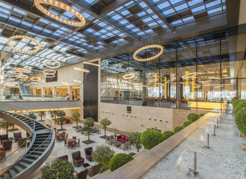 "Siwar Hall at Crowne Plaza Riyadh: Spacious venue with natural light for events and conferences."