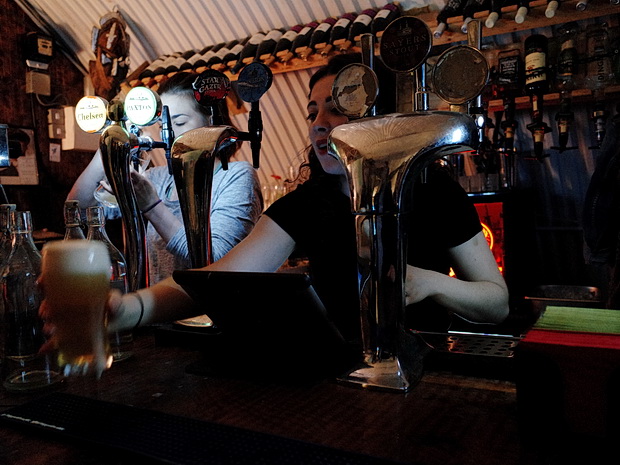Efficient bar service at Off The Cuff live music venue for fast-paced event catering.