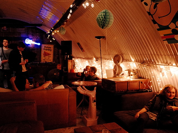 Industrial-chic music bar with lounge seating, ideal for networking mixers and corporate parties.