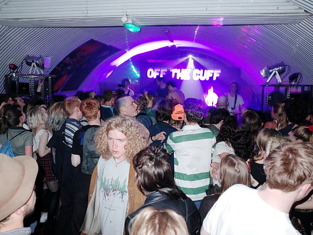 Live music at Off The Cuff: purple neon industrial venue for immersive events.