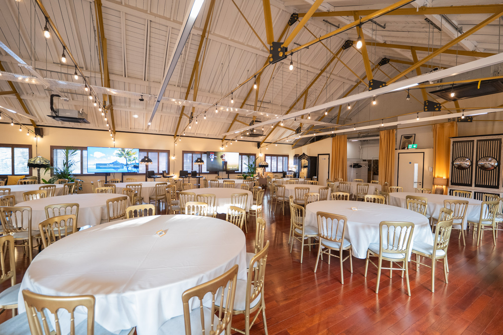 Elegant New Victorian Loft venue with round tables, ideal for weddings and corporate events.