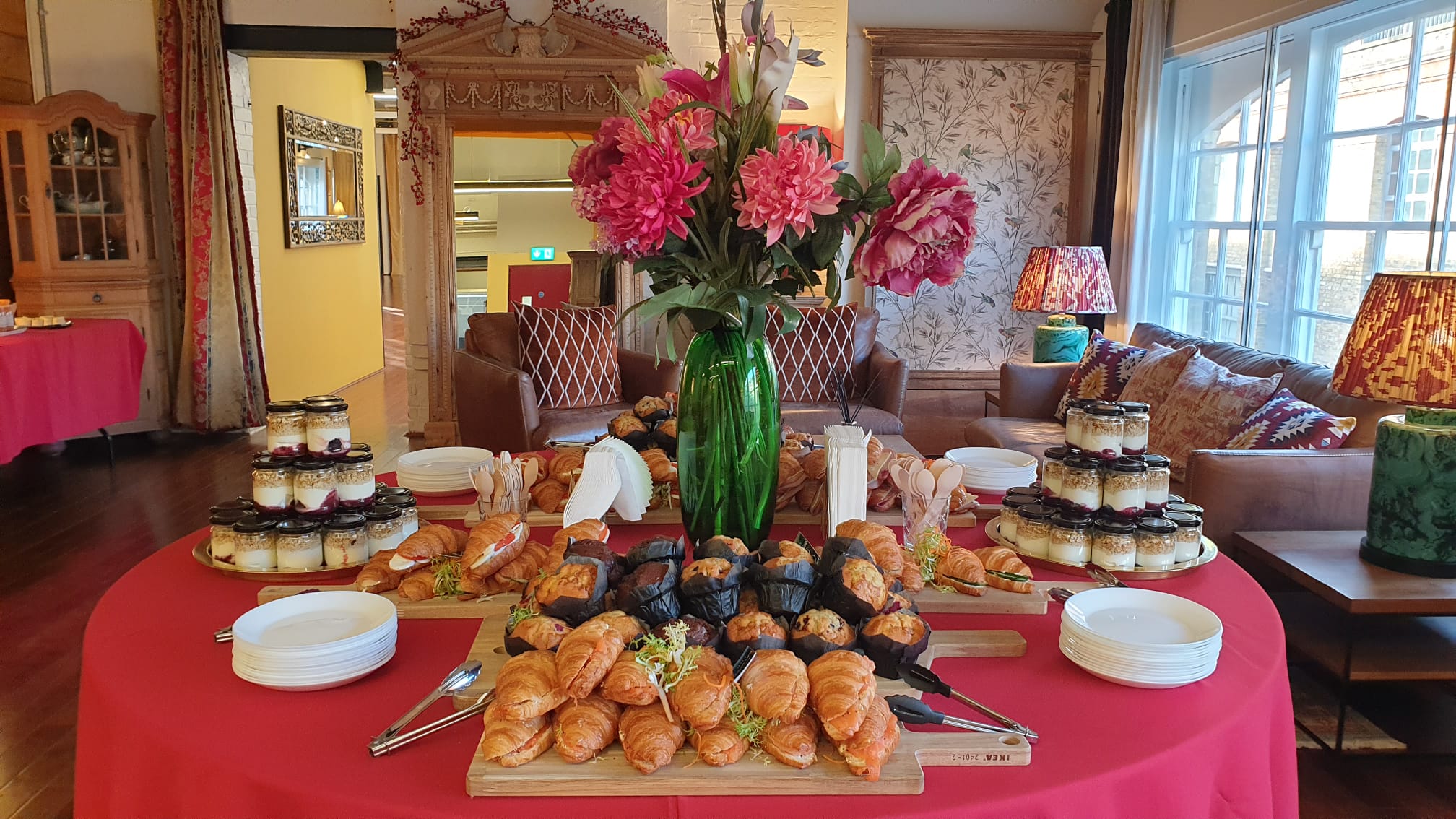 "Elegant refreshment station with floral centerpiece for networking events at New Victorian Loft."