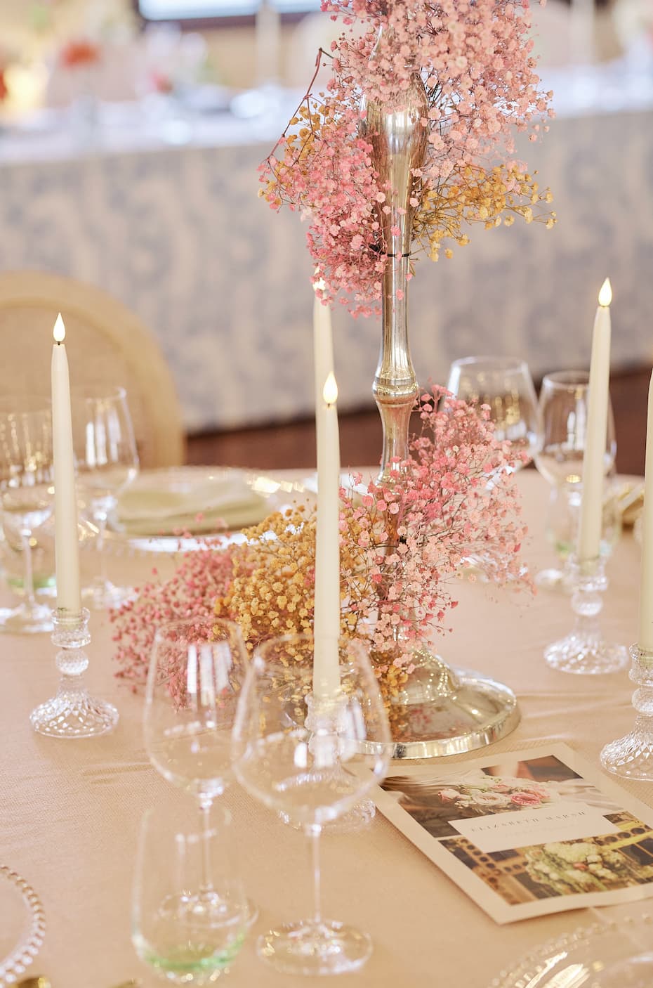 LED taper candles and baby's breath centerpiece at a New Victorian Loft wedding reception.