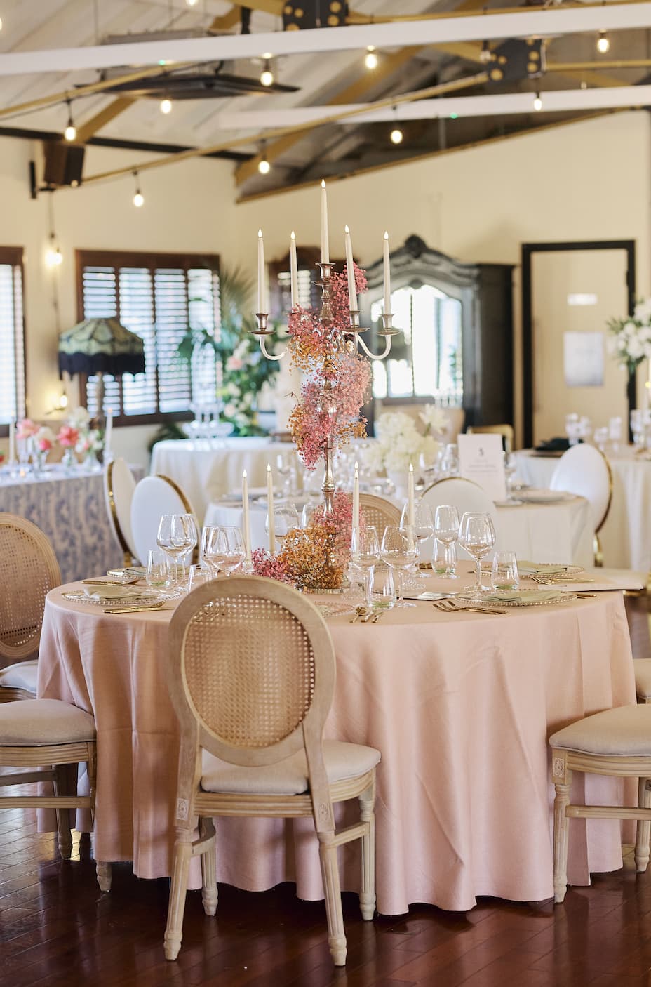 Victorian Loft wedding tablescape with floral candelabras and chic decor.