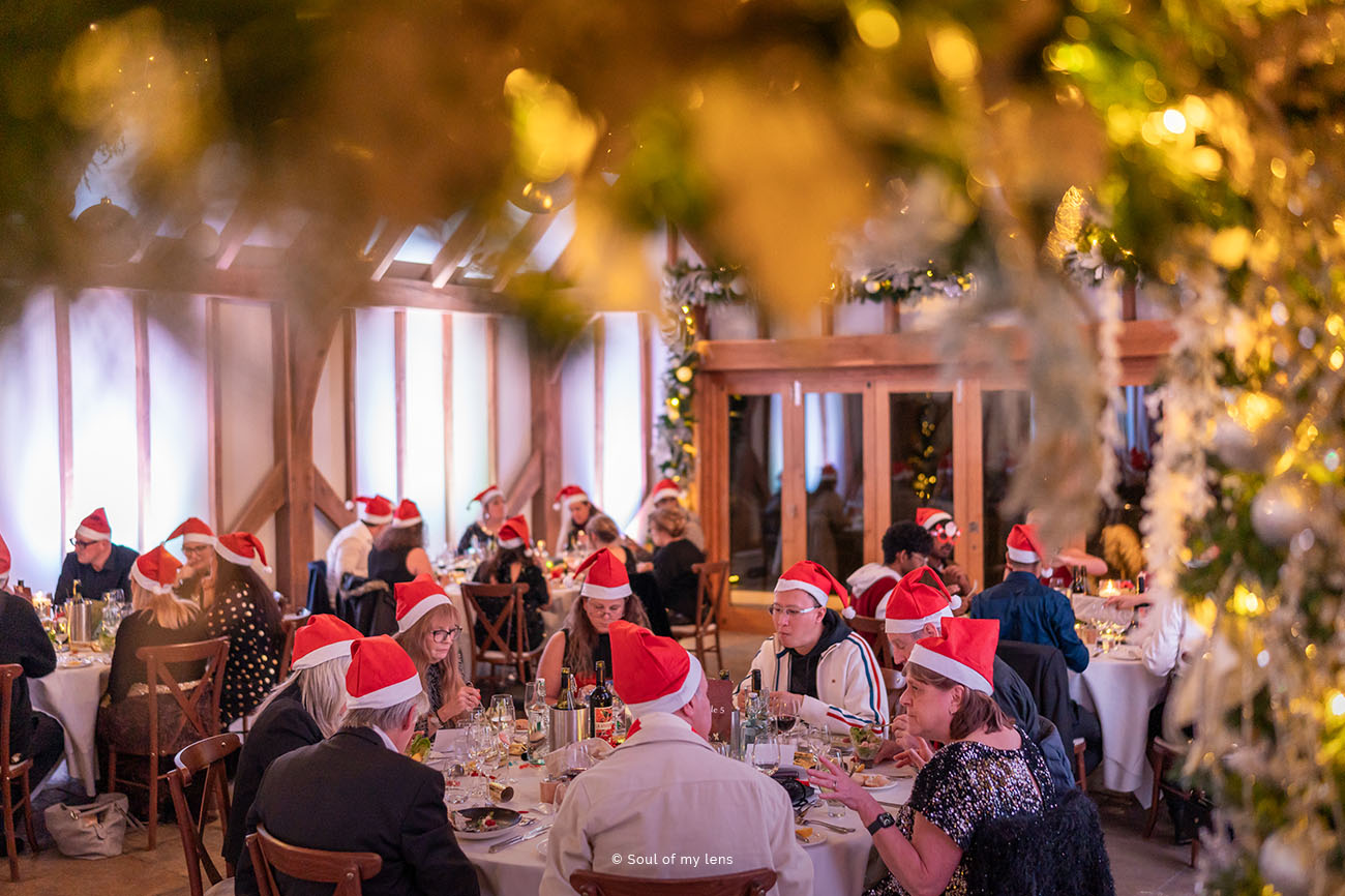 Festive holiday banquet at The Barn in Brookfield with Santa hats and elegant decor.
