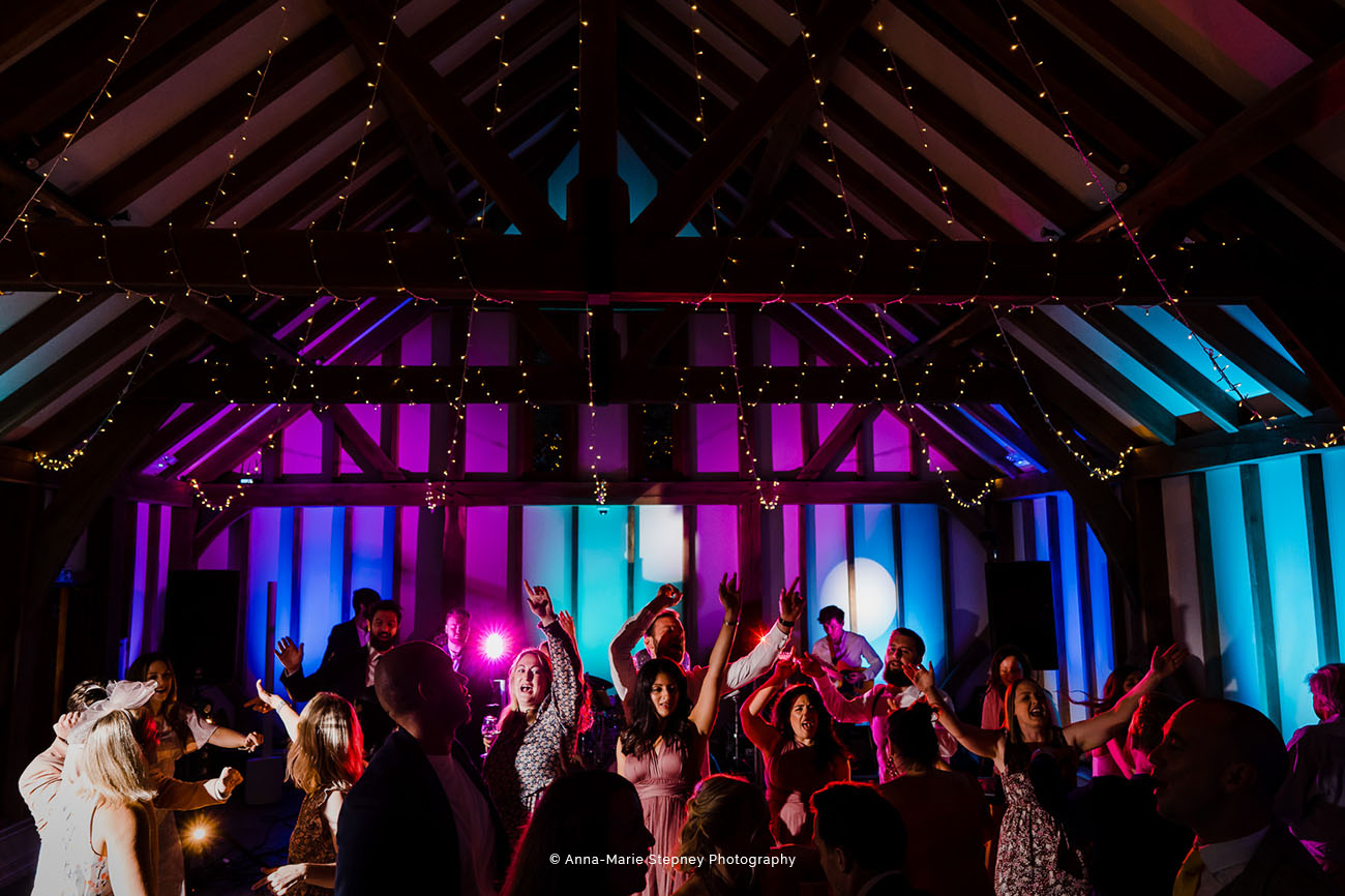 Lively dance floor at The Barn, Brookfield with vibrant lighting for events and celebrations.