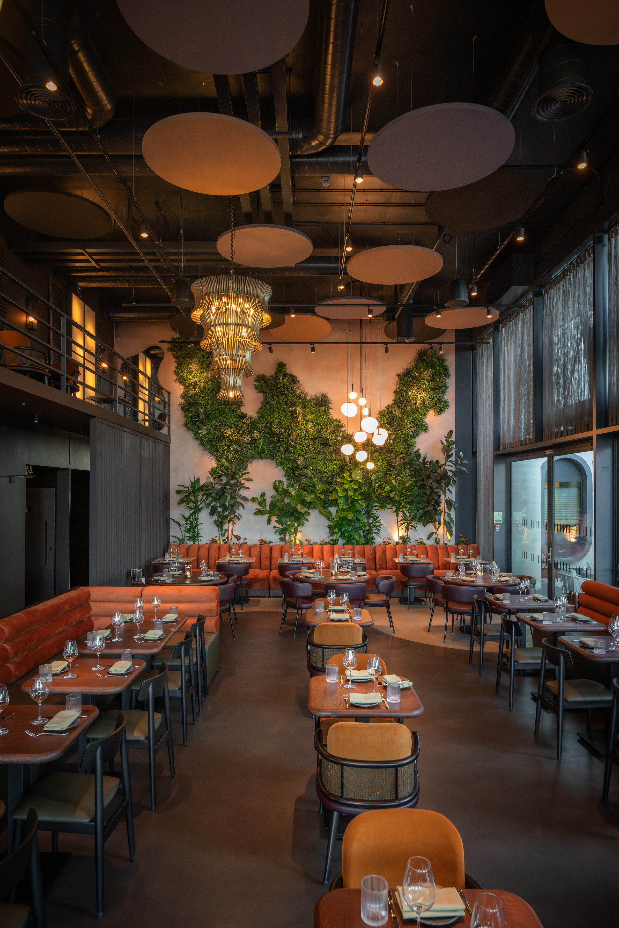 Agora Hall in HERA Restaurant: modern decor, lush greenery, perfect for events.