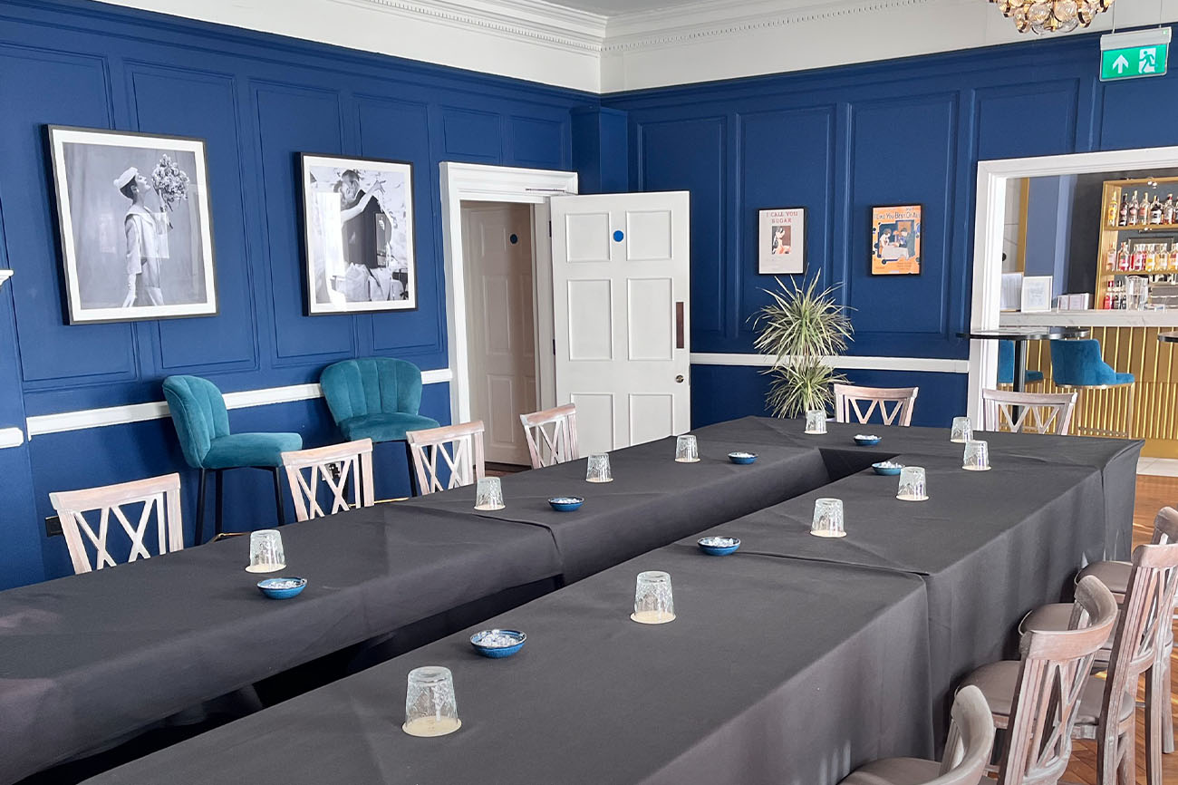 Peploe Lounge meeting room with blue accent wall, ideal for professional events and meetings.