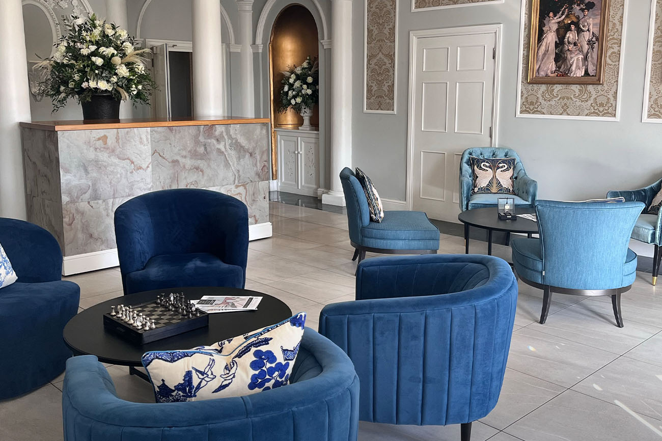 Arrival Hall in Old Palace Chester: elegant blue seating for networking events.