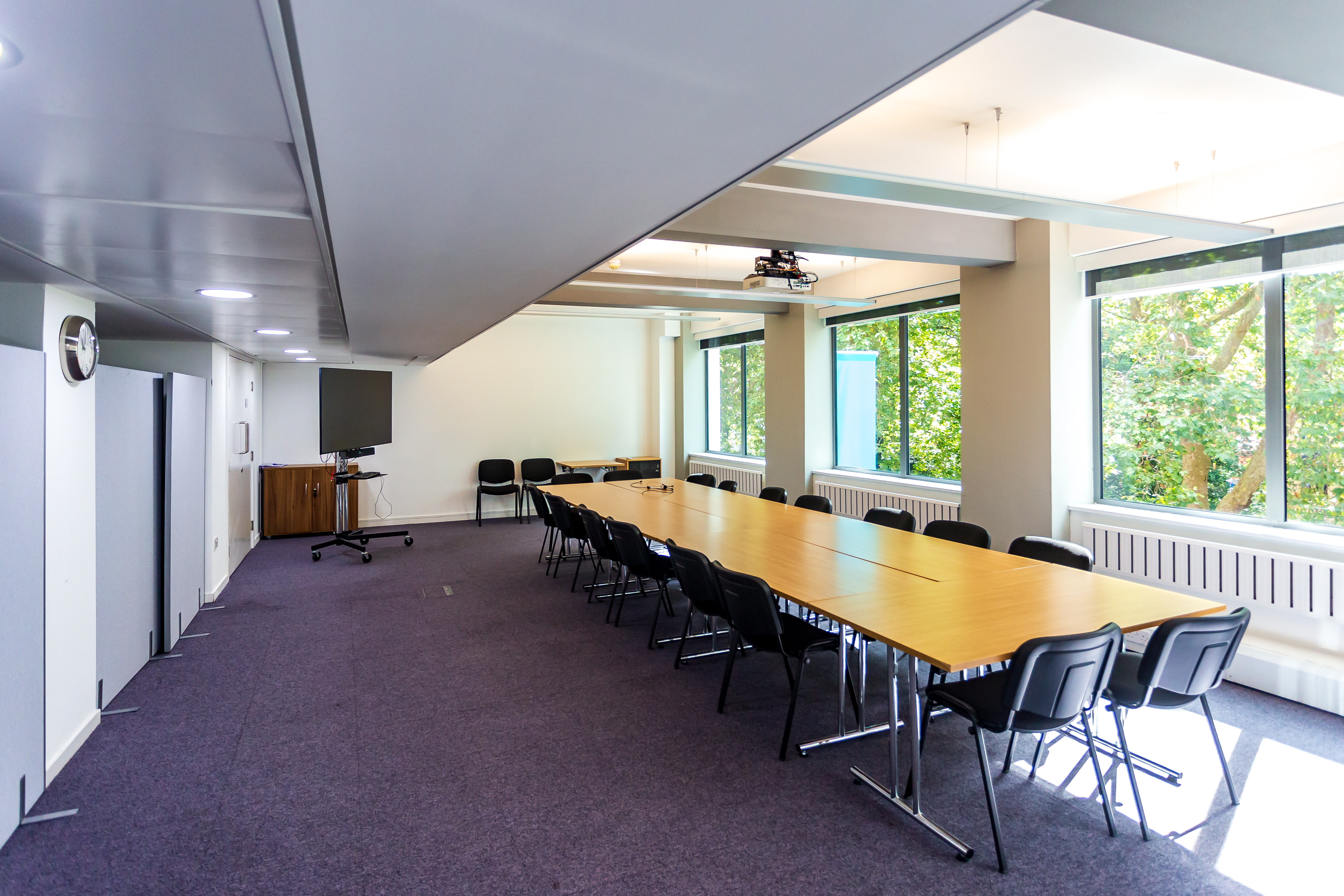 Spacious meeting room in Churchill House for workshops and conferences, featuring natural light.